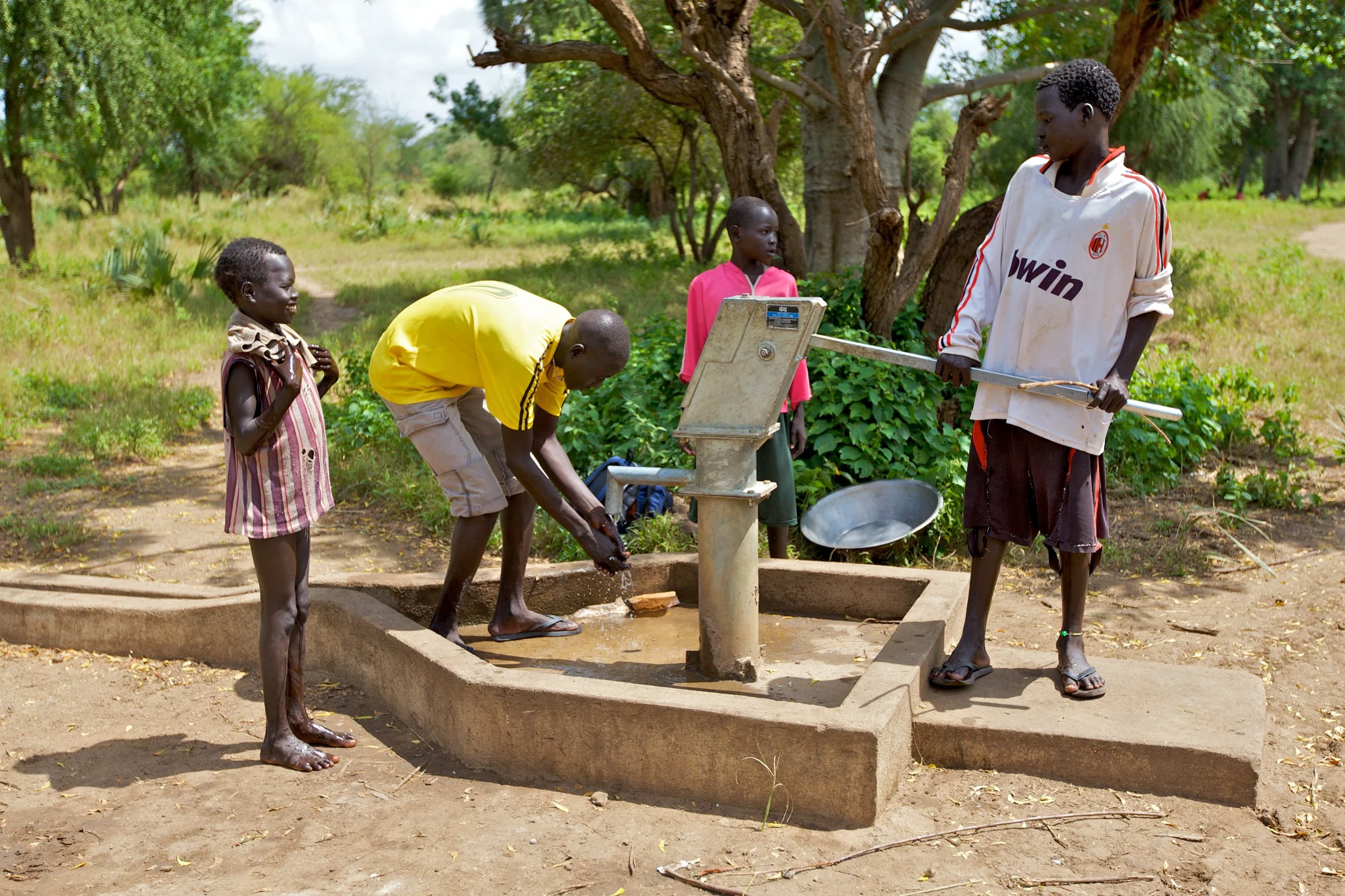 Young men use a borehole installed by SIM