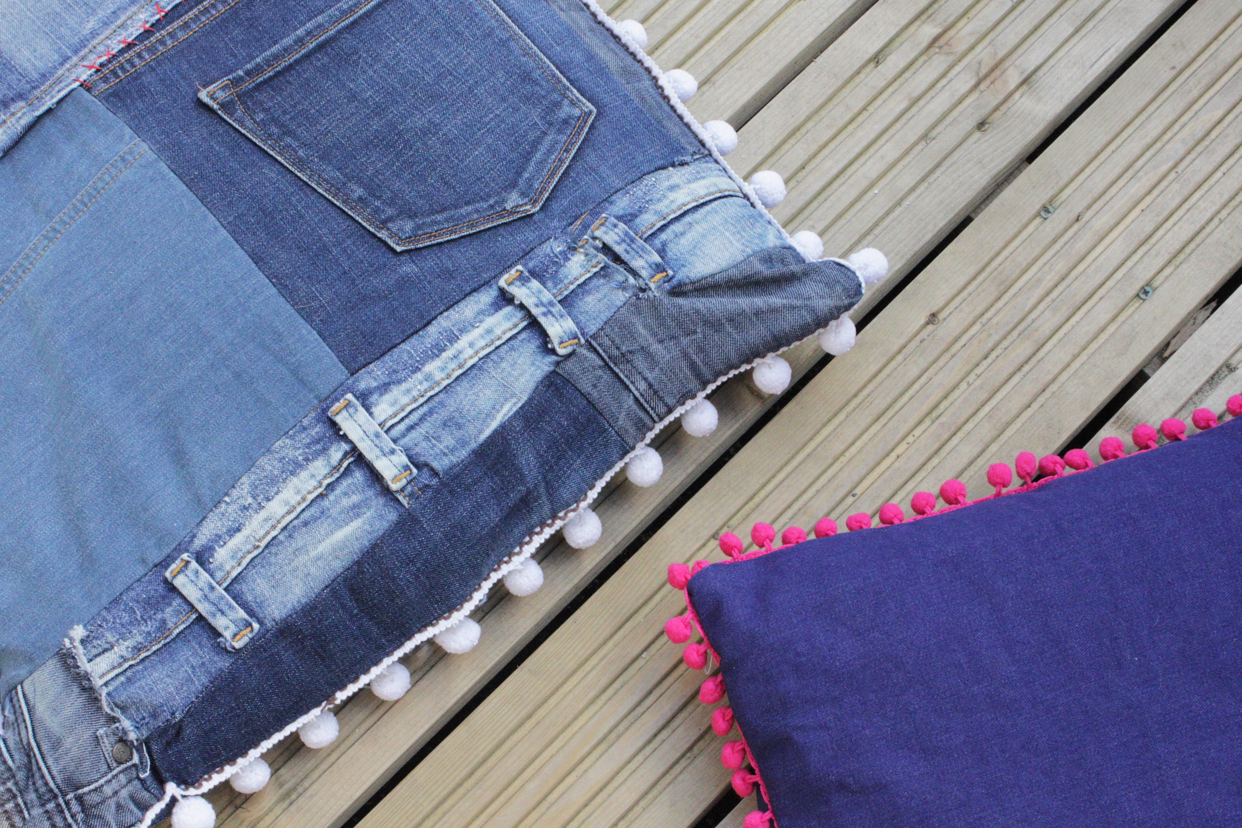 Jeans cushions with a pompom trim
