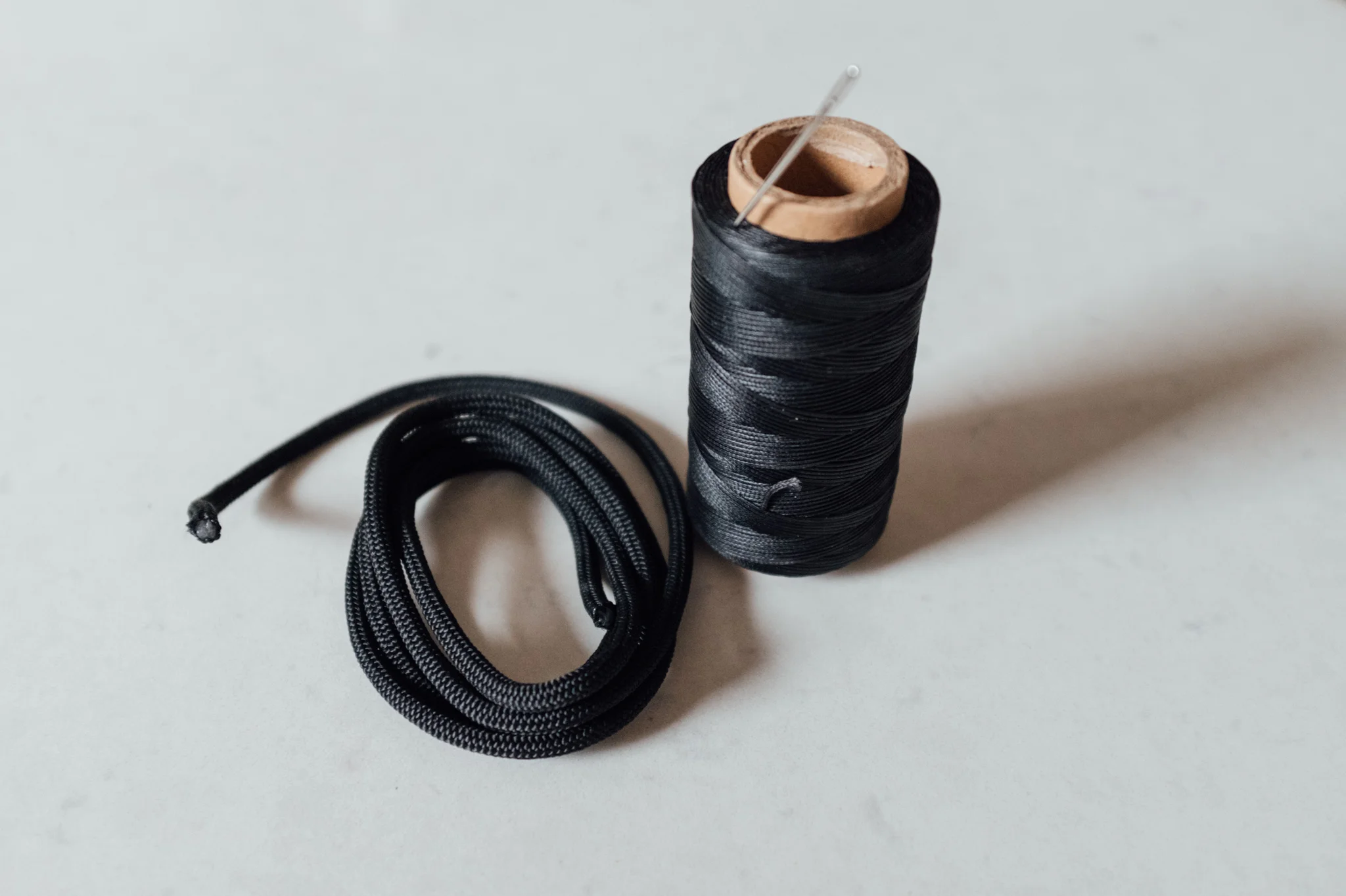 Wax thread, simple climbing line and a big needle is pretty much all you need. 