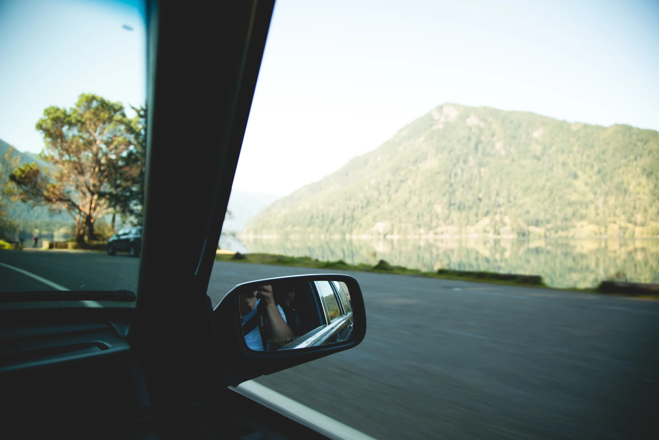 Isaiah snagging a pic of a lake with near perfect reflections on the way to Forks.