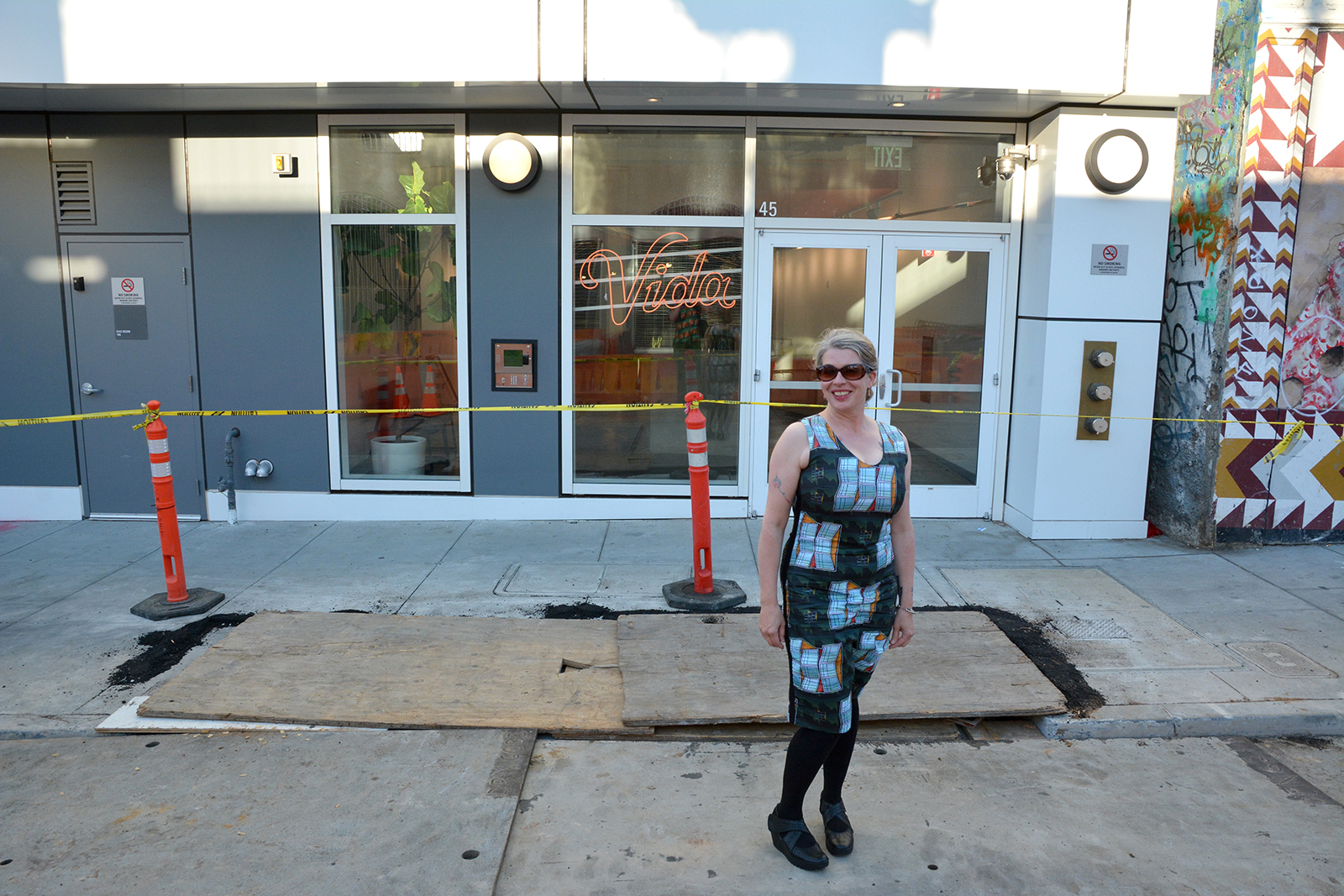 Mel shows off "Mission Condo" dress in front of the condo that inspired the design.
