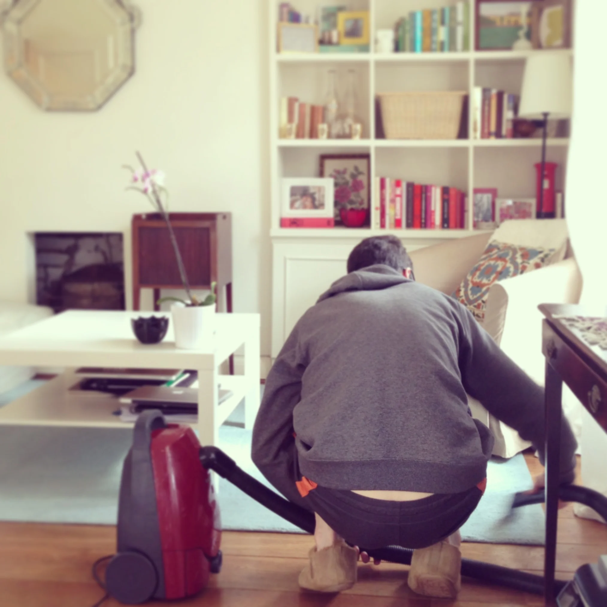 Tyler vacuuming our flat before it was shot for Apartment Therapy. I was a week away from delivery!