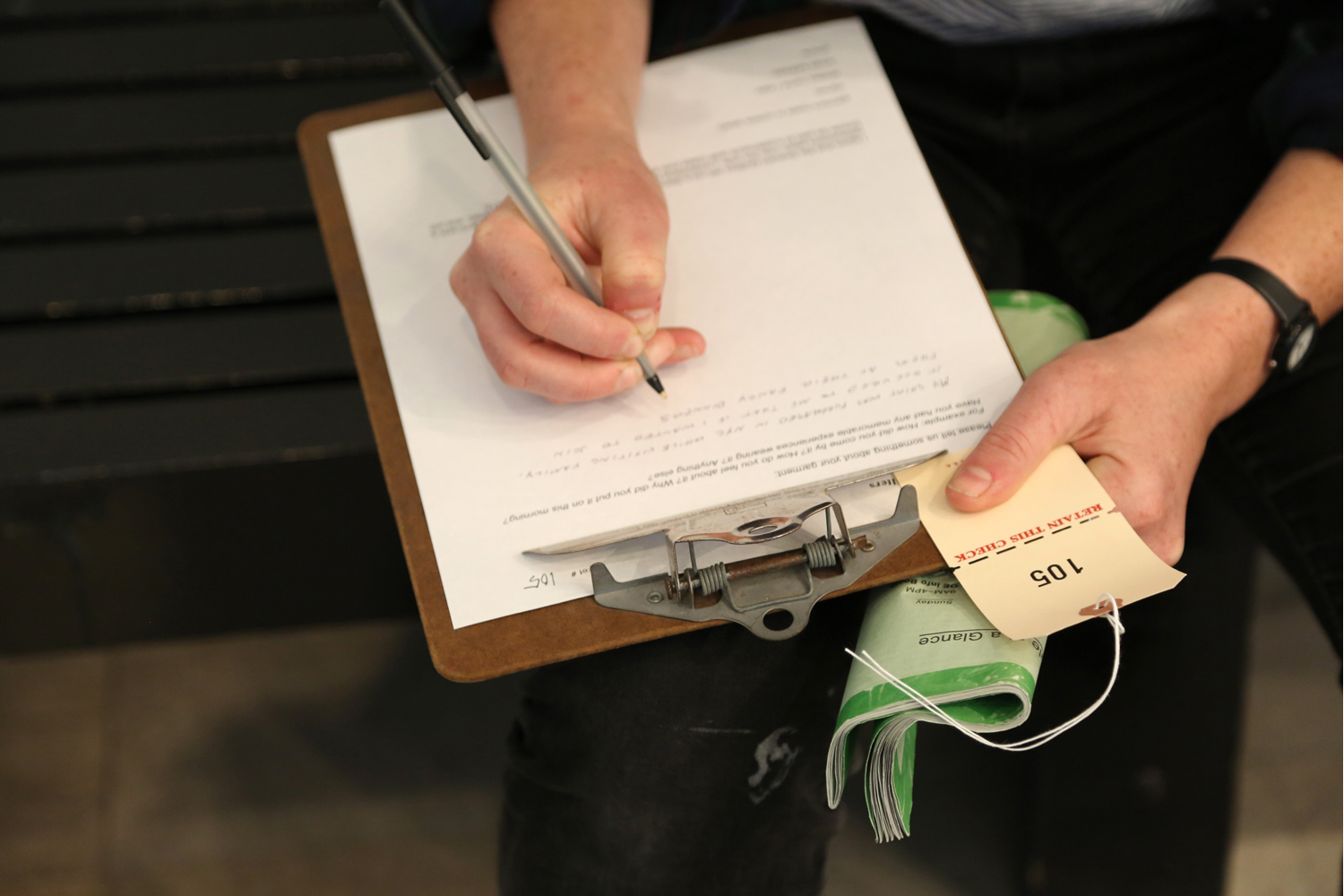  Participants remove and hand over a garment, in exchange for a numbered tag 