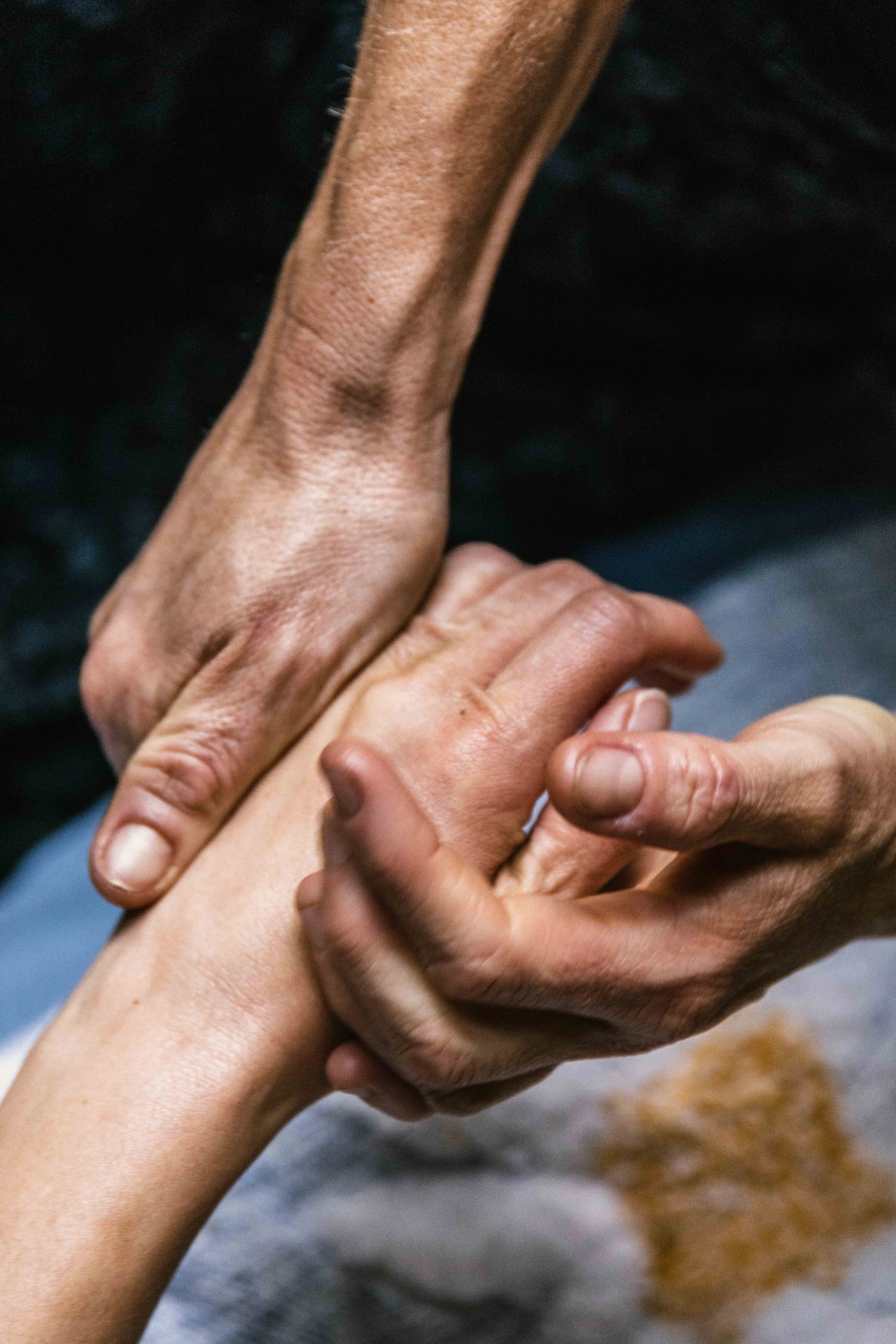 the hands of massage therapist Lindsay Gaby massage the hand of their client — a local master esthetician named Kahlia.