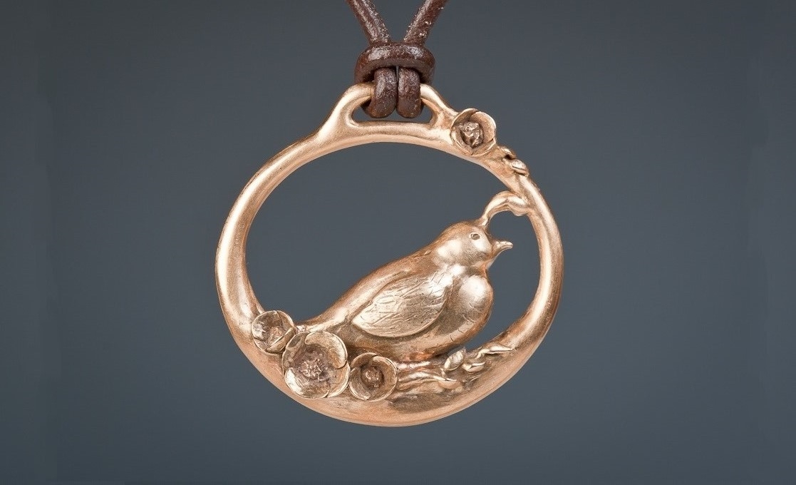 Quail and Poppies Pendant in Ancient Bronze. Photograph by Sarah Breivis.