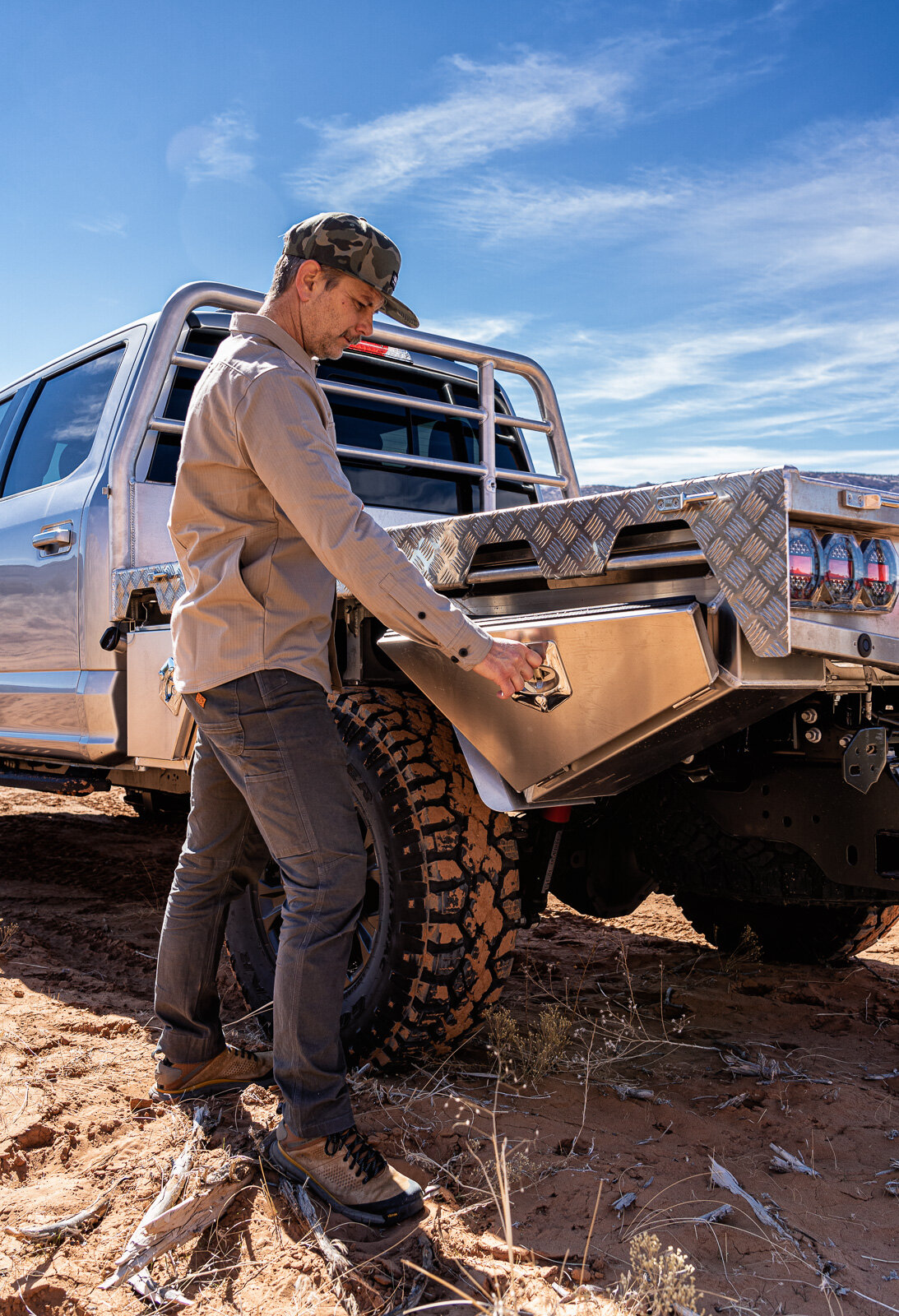 Man Wearing Off the Grid Surplus Trailblazer Pants Opens Storage