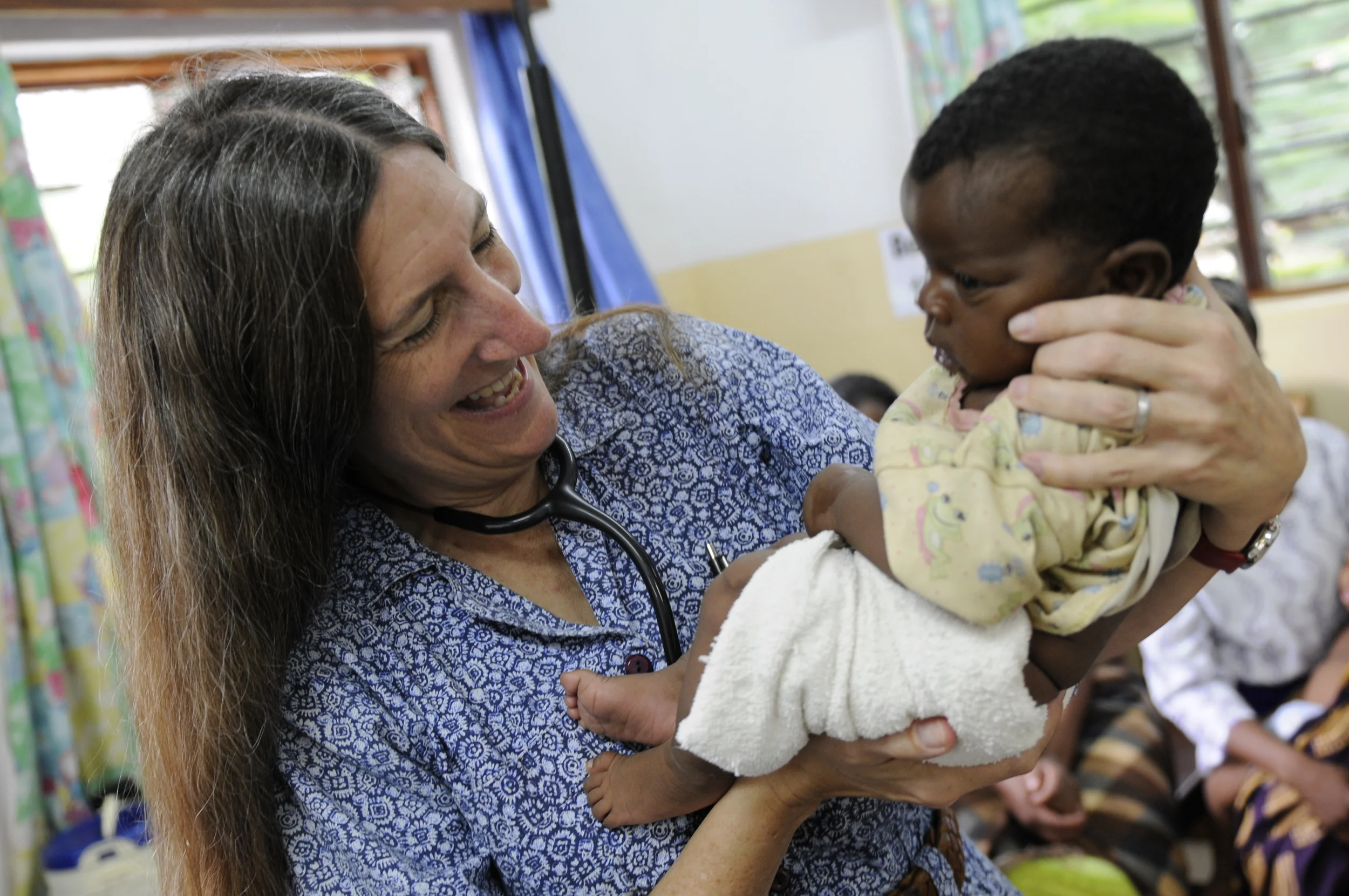   Taylor smiles at a baby at Queen Elizabeth Central Hospital in Blantyre, Malawi, Africa.  