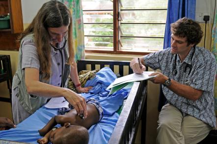 Karl Seydel and colleague Terrie Taylor with a patient in Malawi, where MSU has been helping people with malaria for 28 years. Photo by Jim Peck.