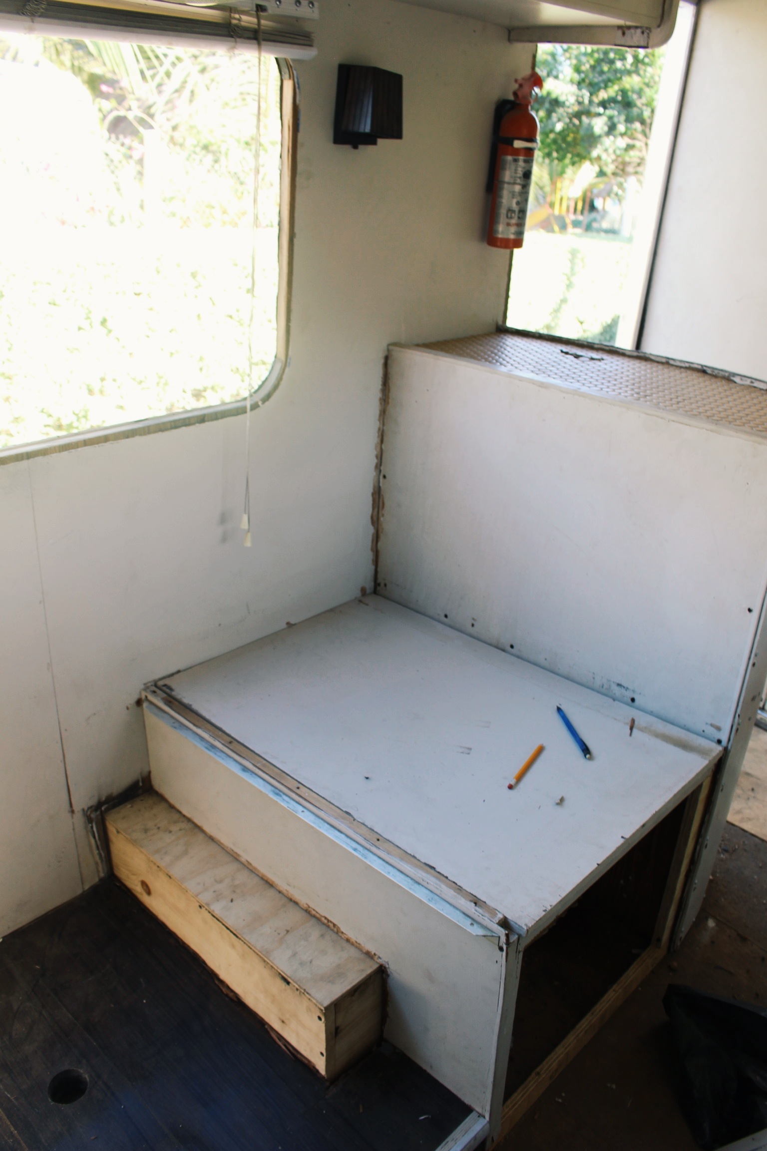 The back side of the entry cabinet, which doubles as the dining seat backrest, which sits on top of the wheel well and also serves as a cabinet. Everything multitasks in an RV.