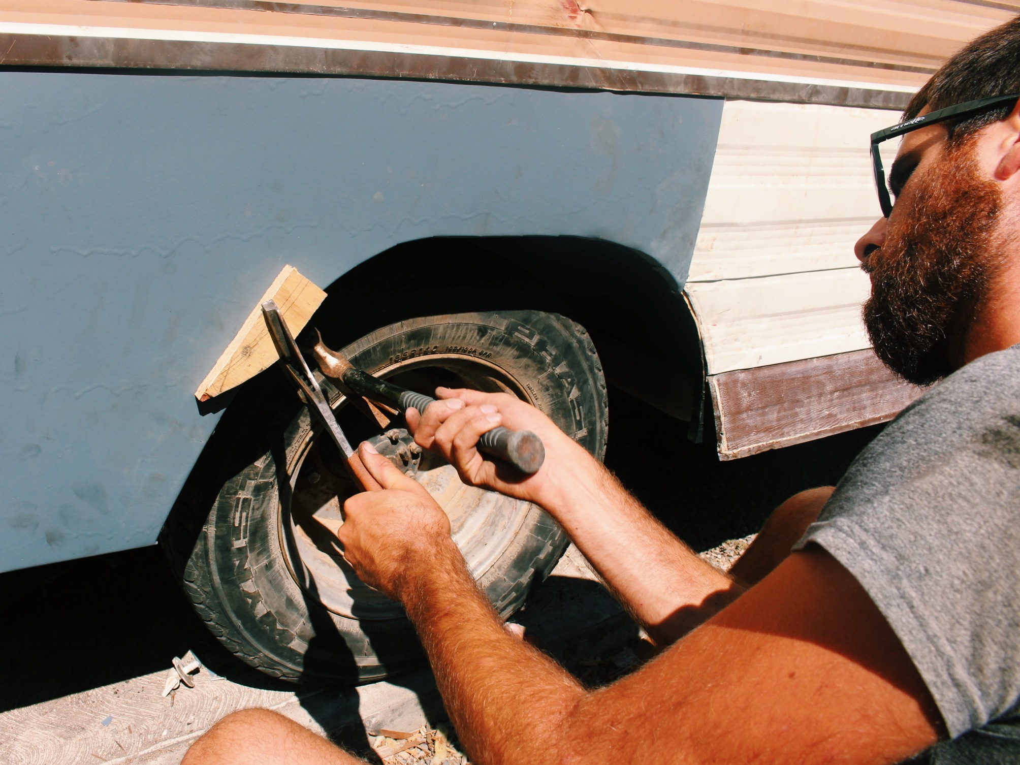 With a block of wood, a pair of pliers and a hammer I could shape the metal around the contour of the wheel well. 