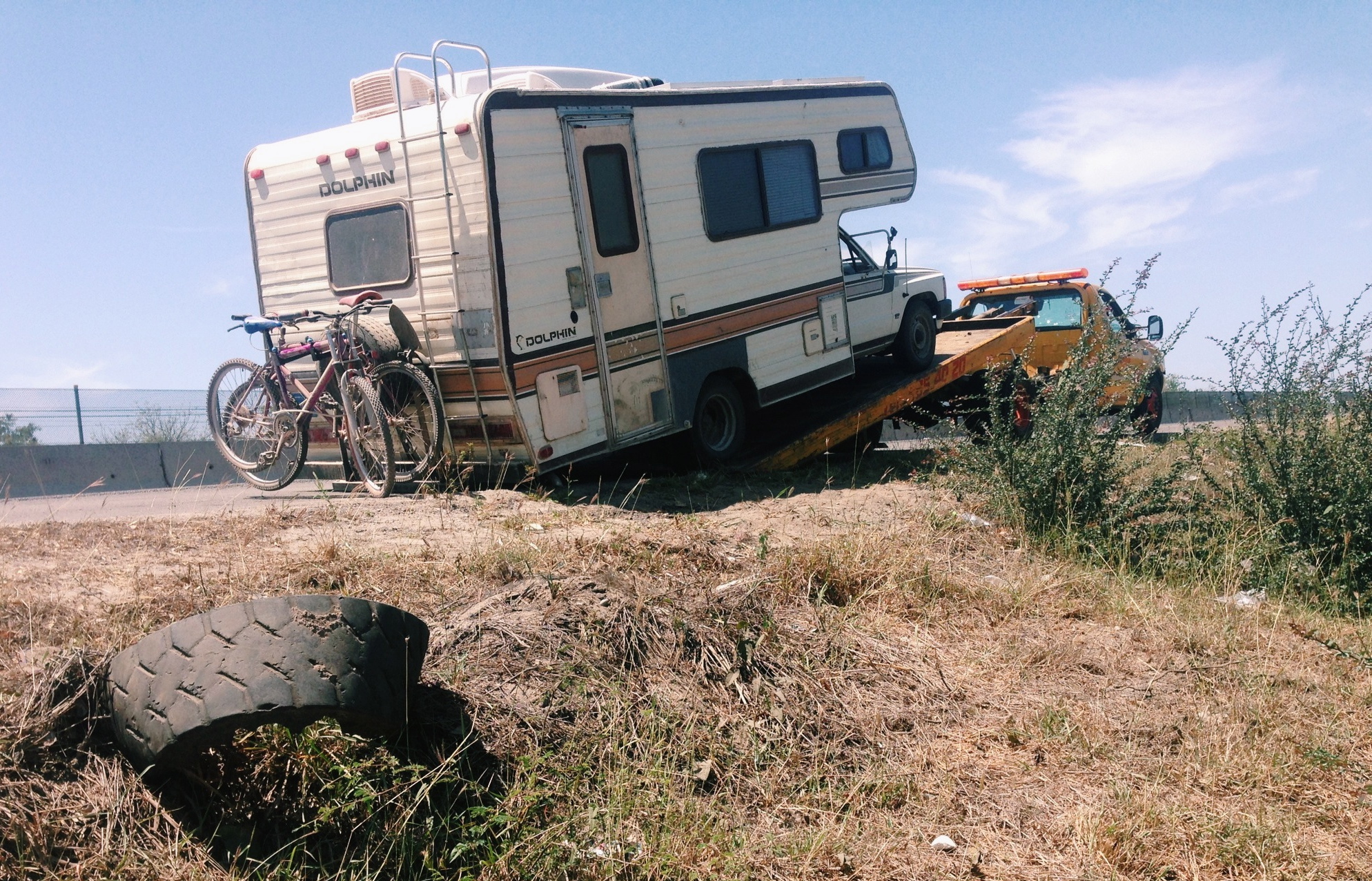 Bumper dragging while the Dolphin gets loaded on another tow truck.