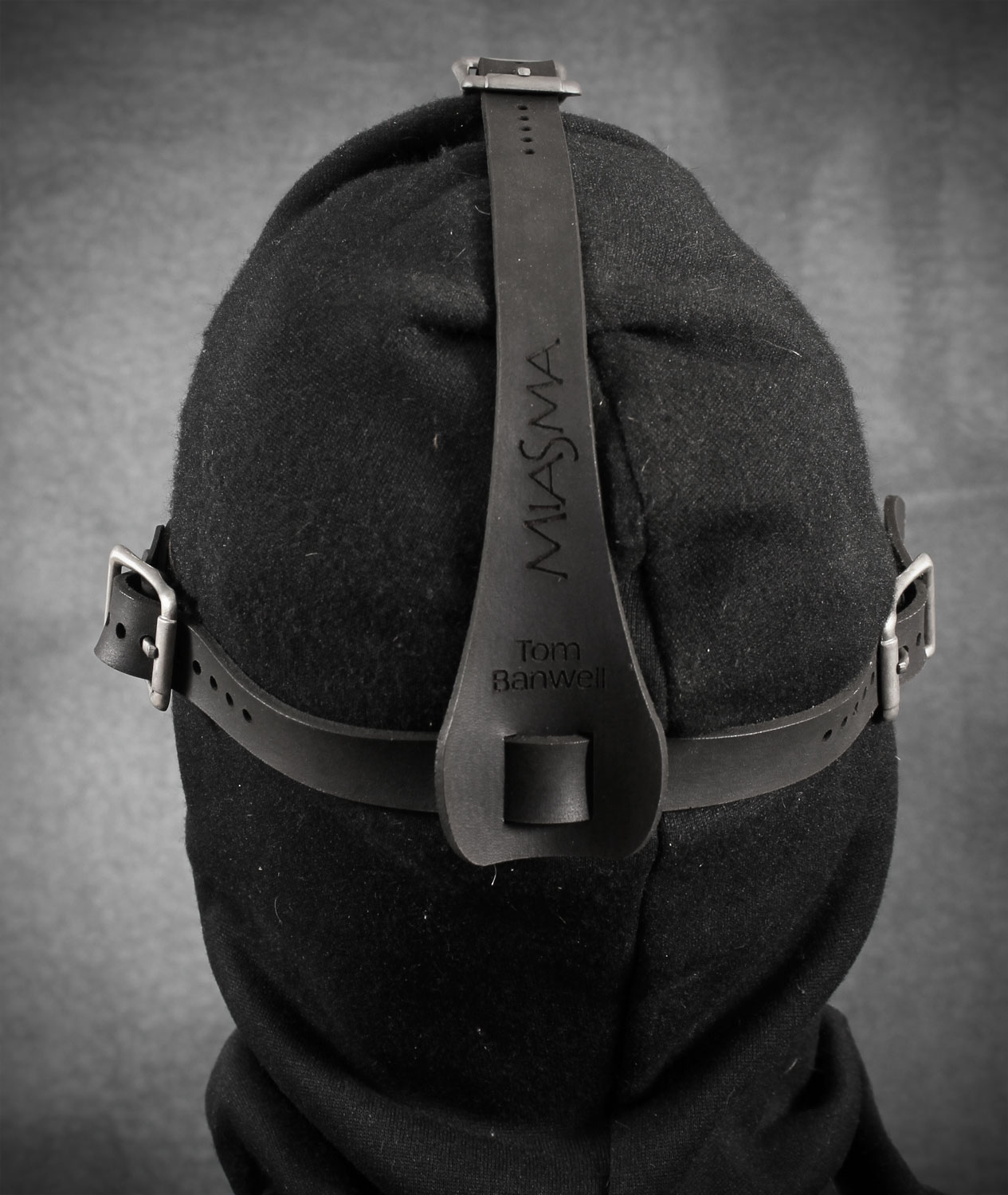 Back of Miasma shown over a balaclava