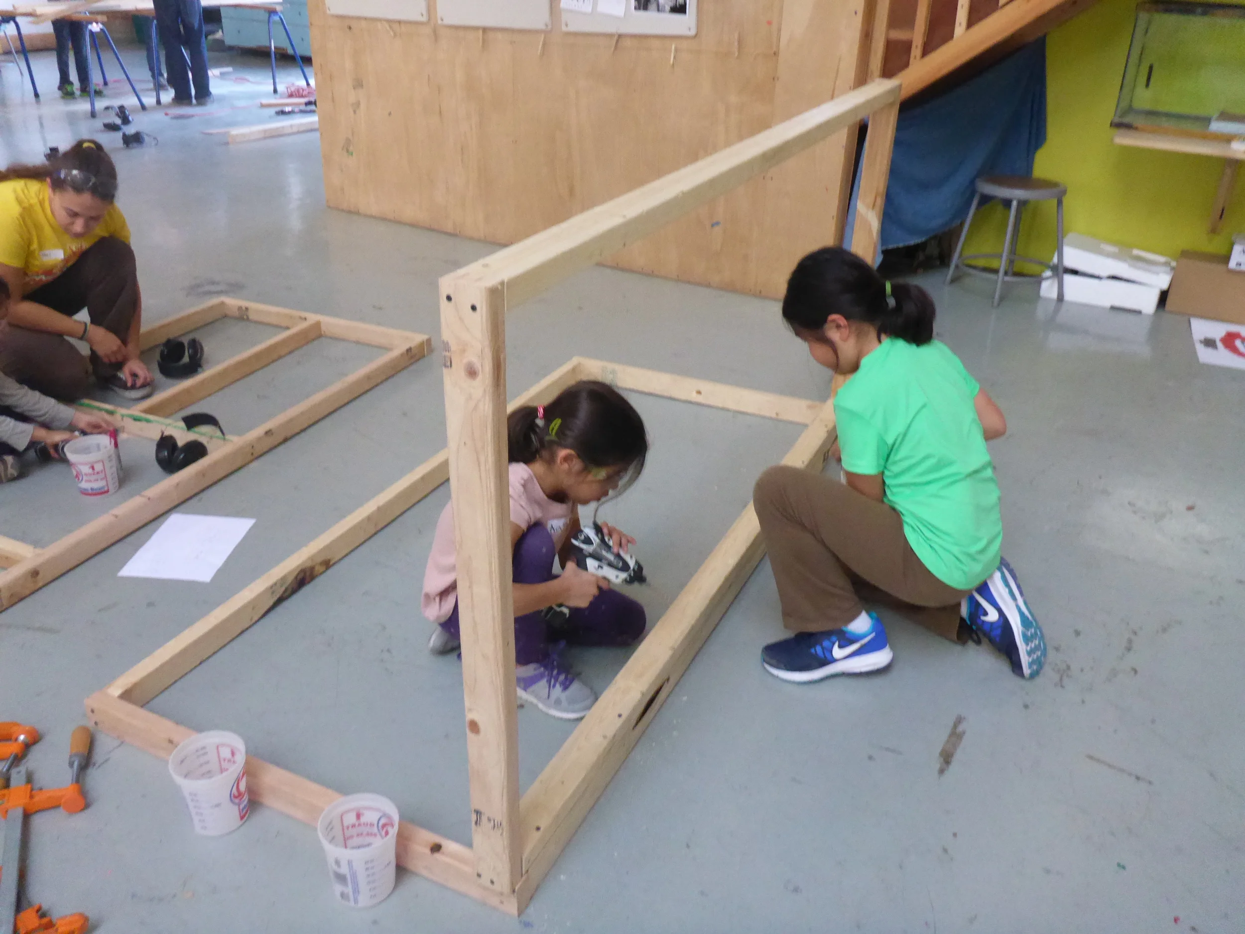 Aasha and Ava attach to walls of the Ticket Booth together.