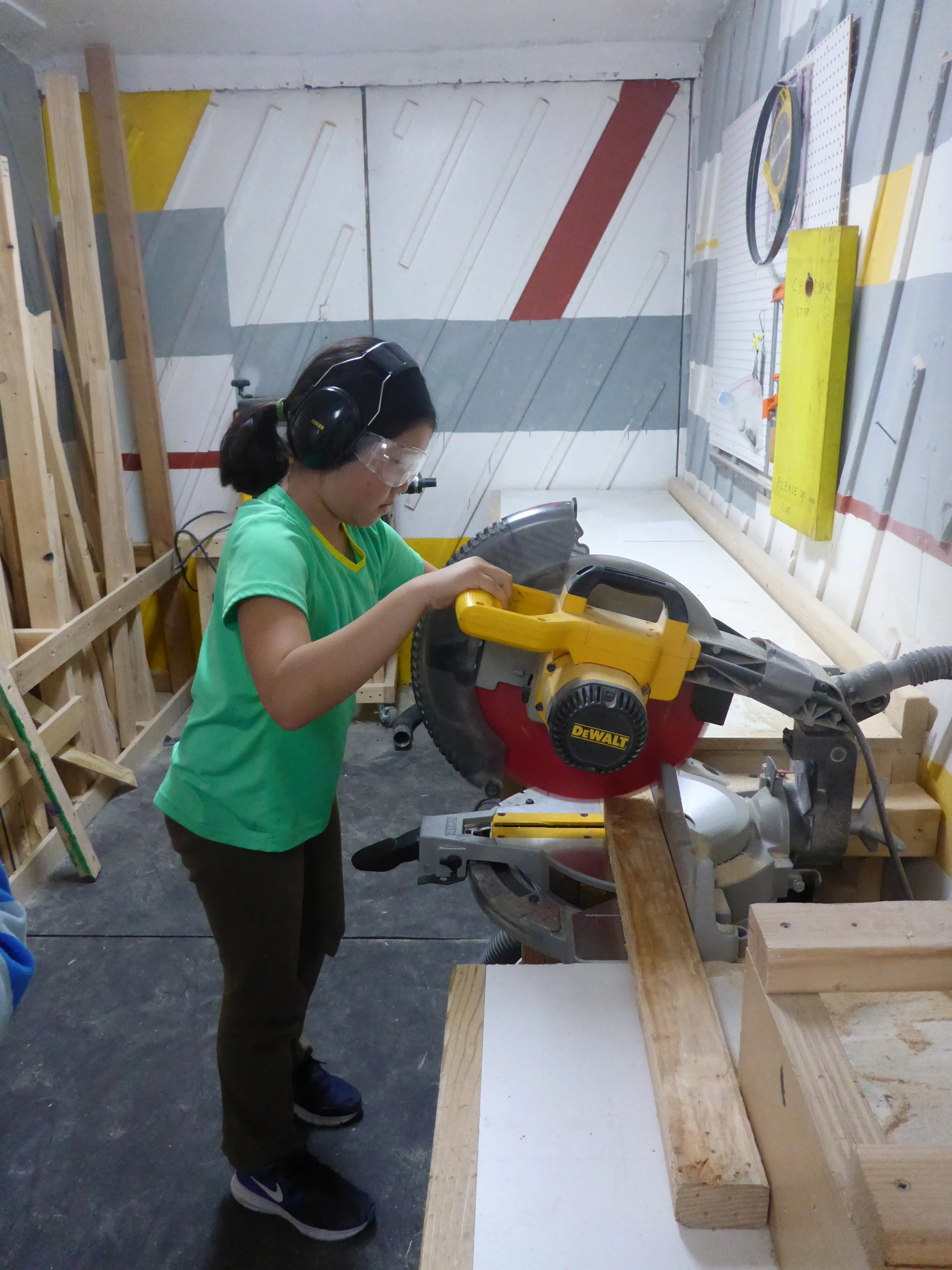 Ava makes a cut on the chopsaw!