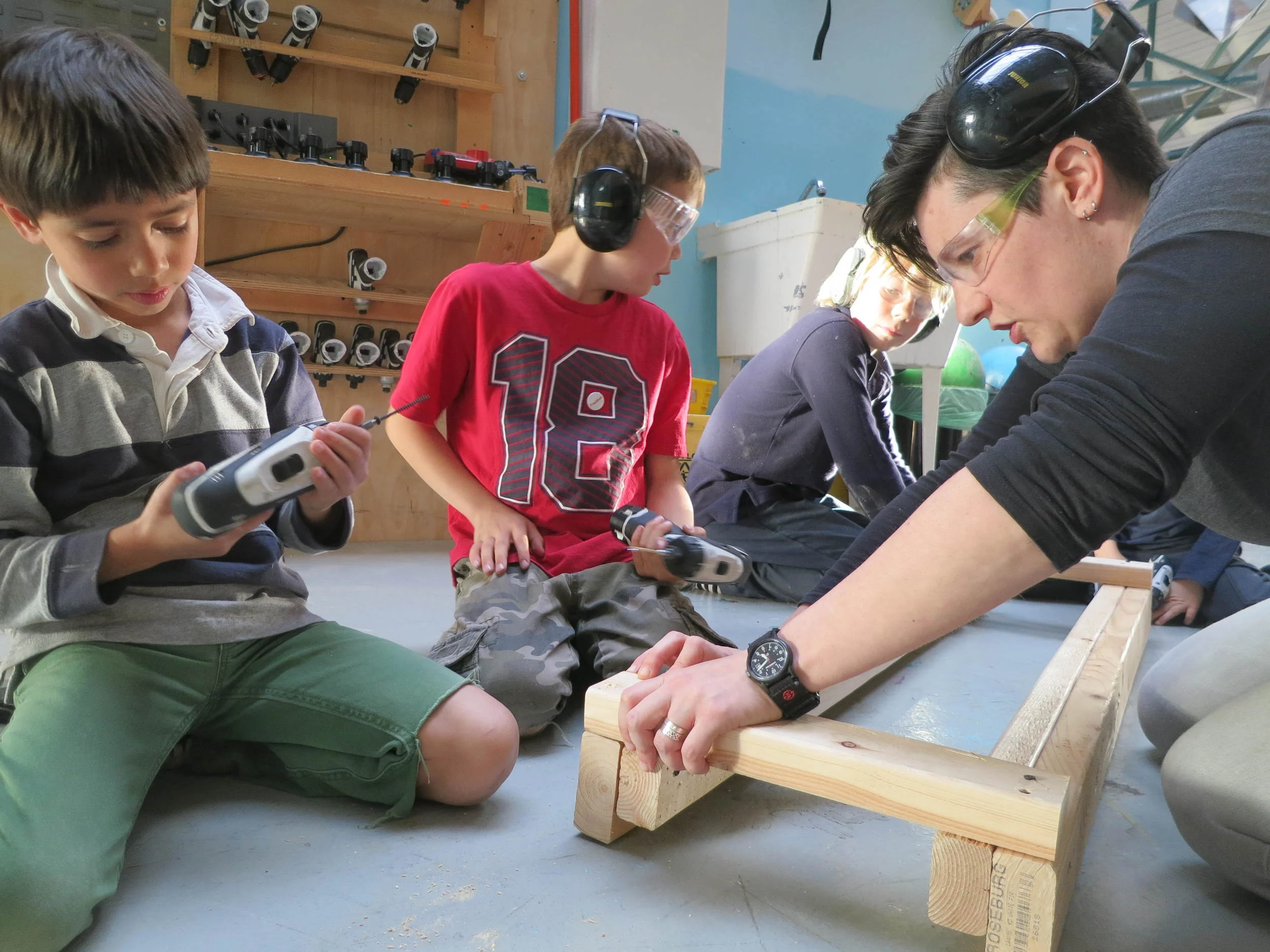 Anand and Justin team up with drills to help assemble the track prototype.