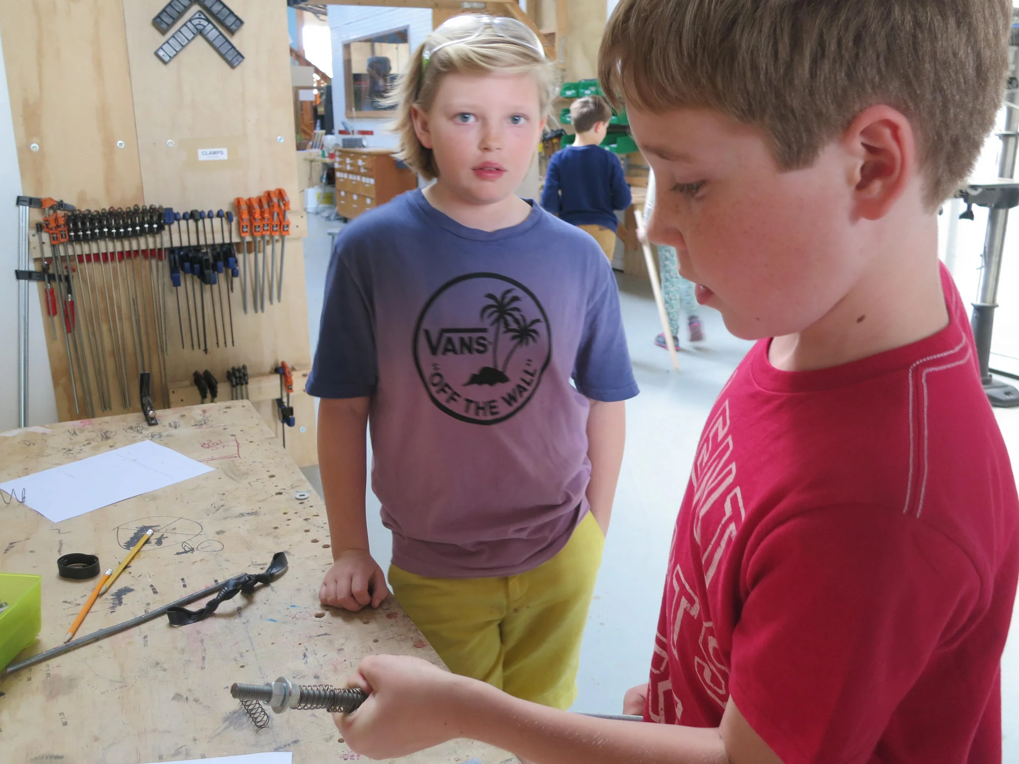 Henry tests out how adding a second spring increases the tension on the rod of the ball launcher