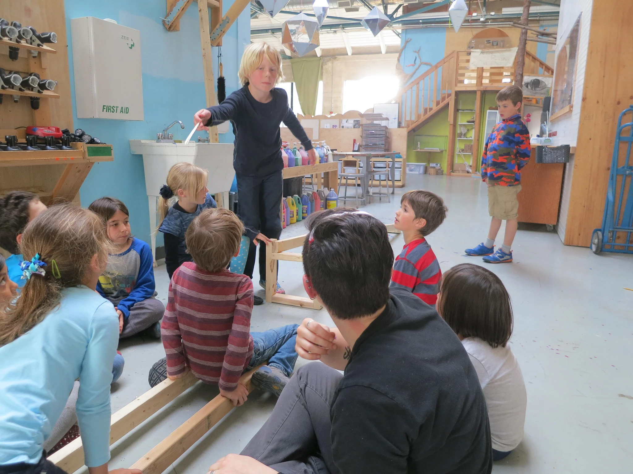 Lincoln shares with the rest of the group a plan to rise the track segments into the air. 