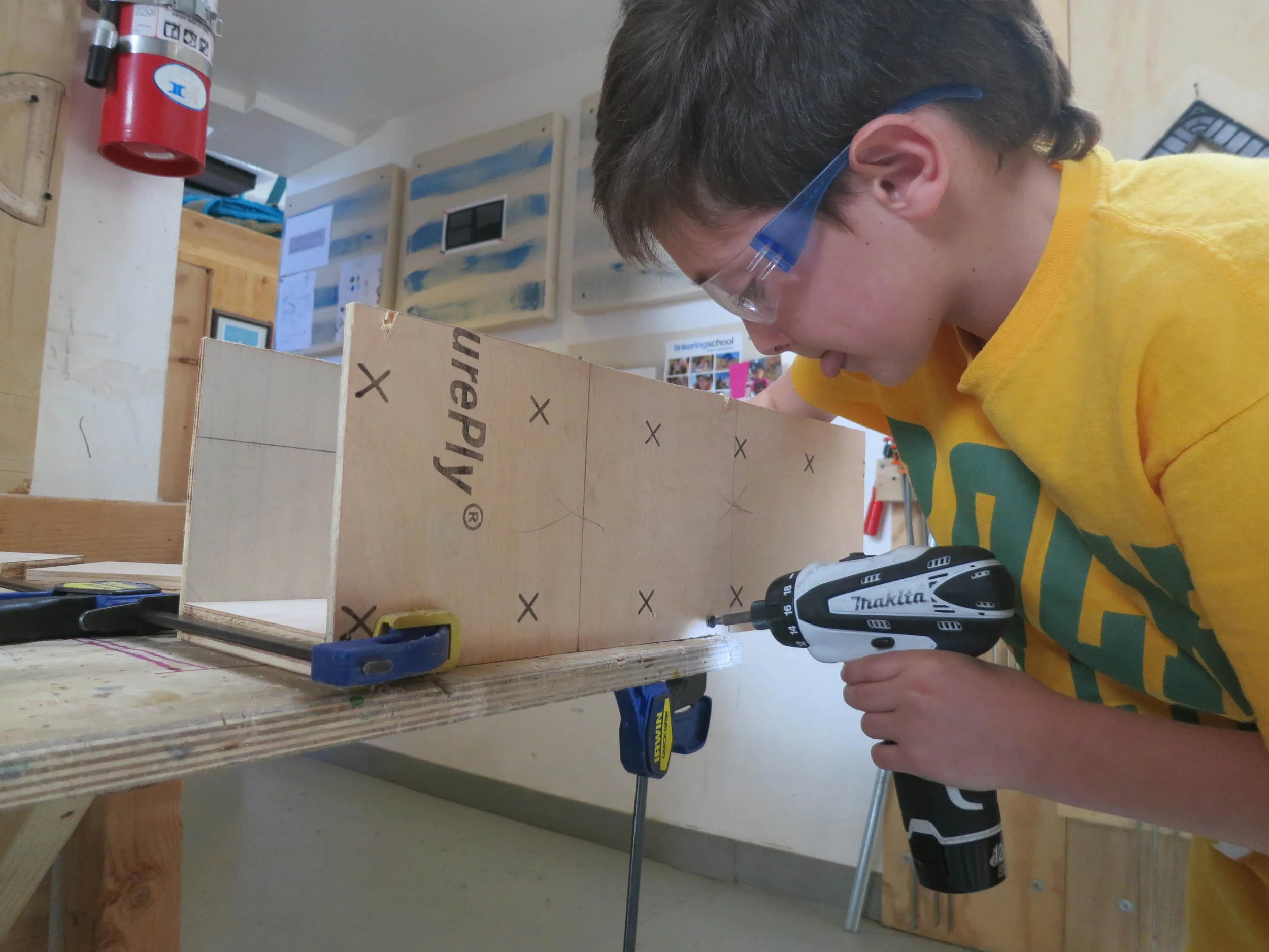 Nico works on completing the container to house the coil dispenser 