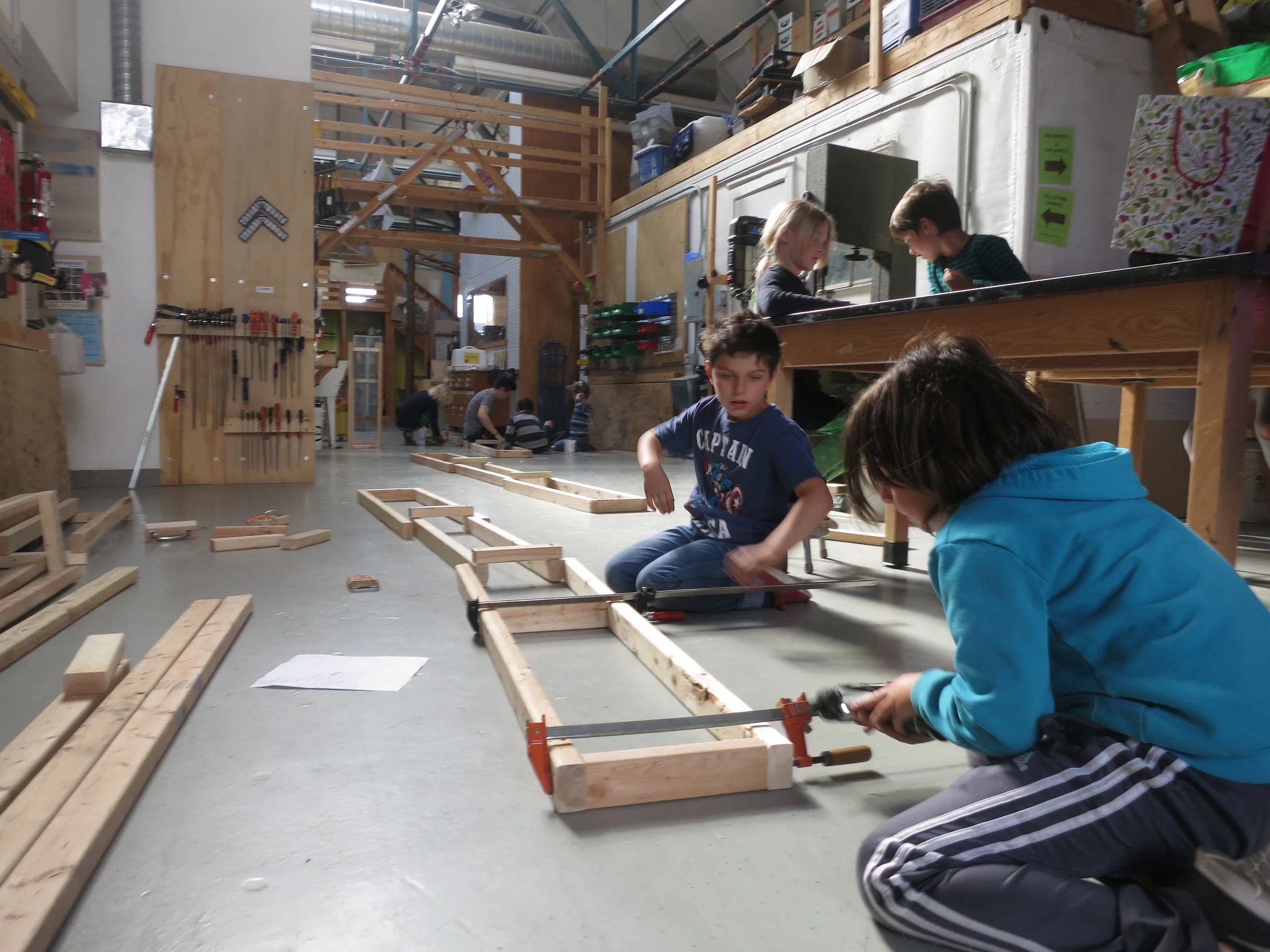 Teamwork time! Noah and Luca work together constructing the ramp holders and setting them in place to keep the entire operation flowing smoothly.