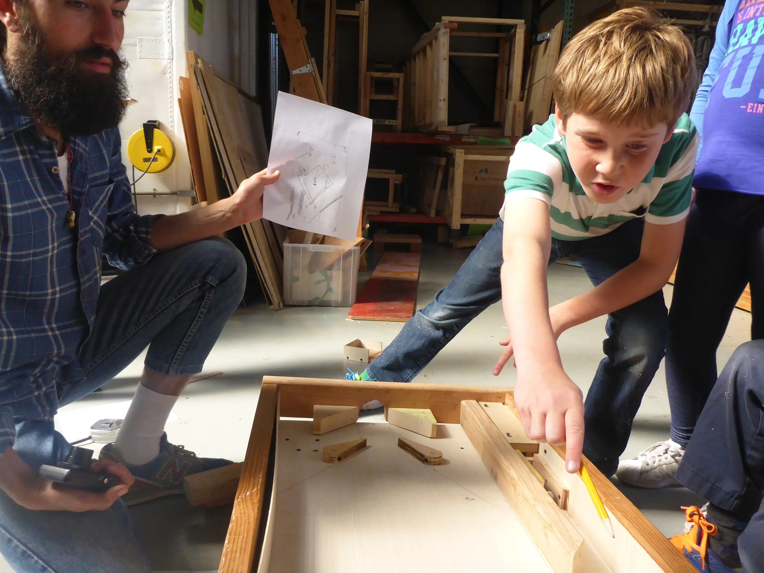Henry shares his design pointing out where the obstacles will be on the board.
