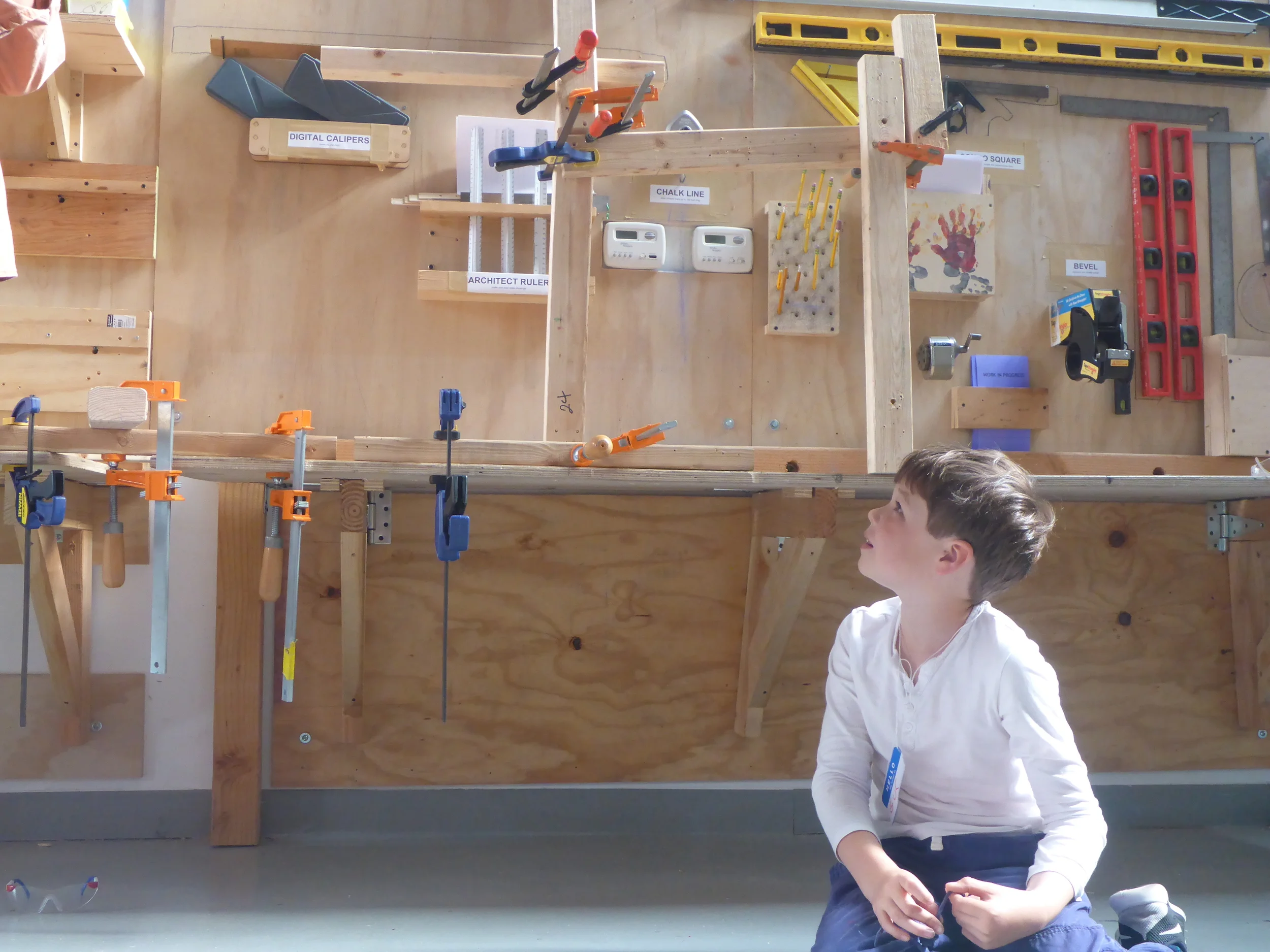 Gus admires the structure that everyone built using scrap wood and clamps. 