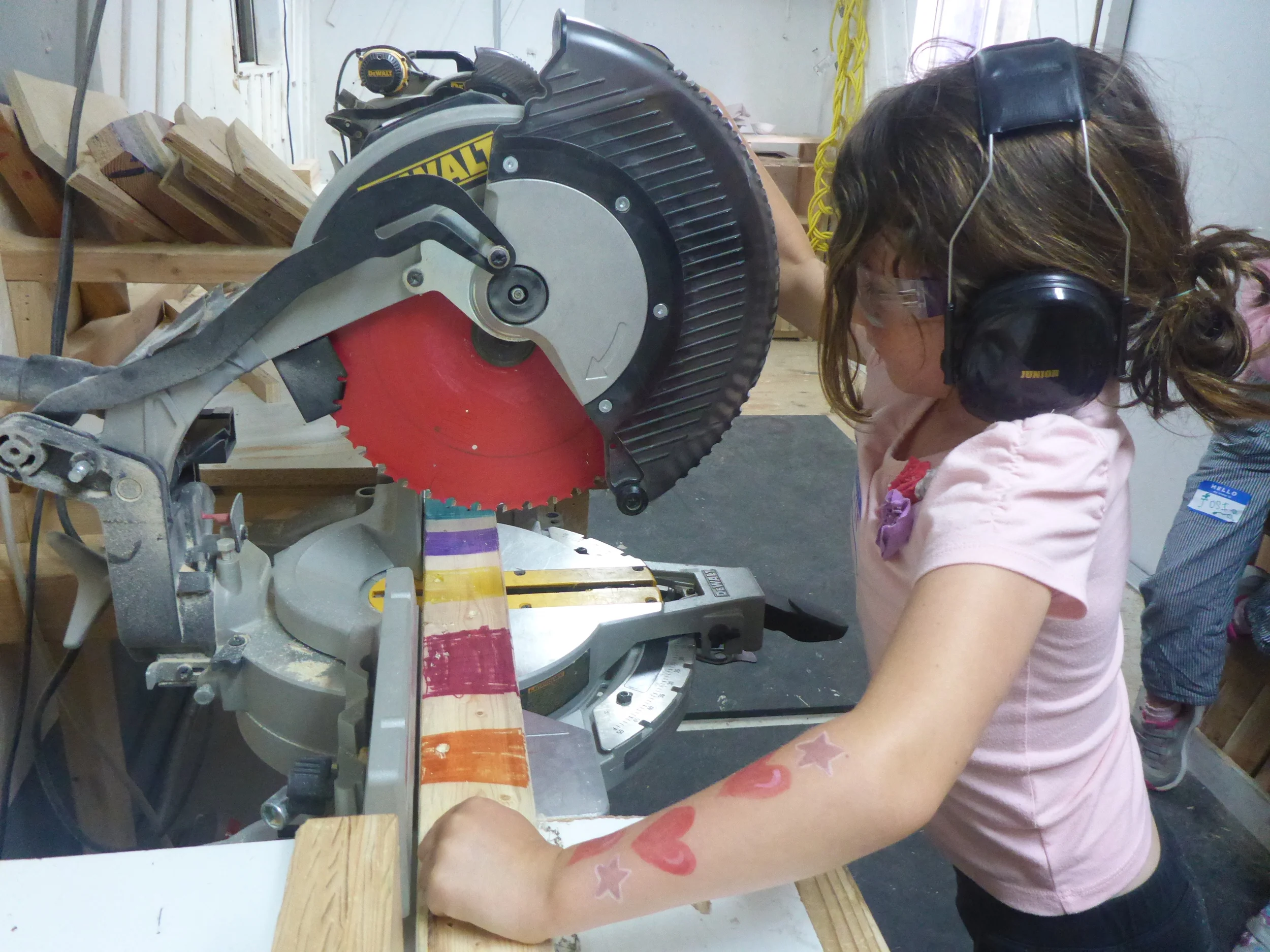 Keira preparing to cut some very, very colorful wood. 