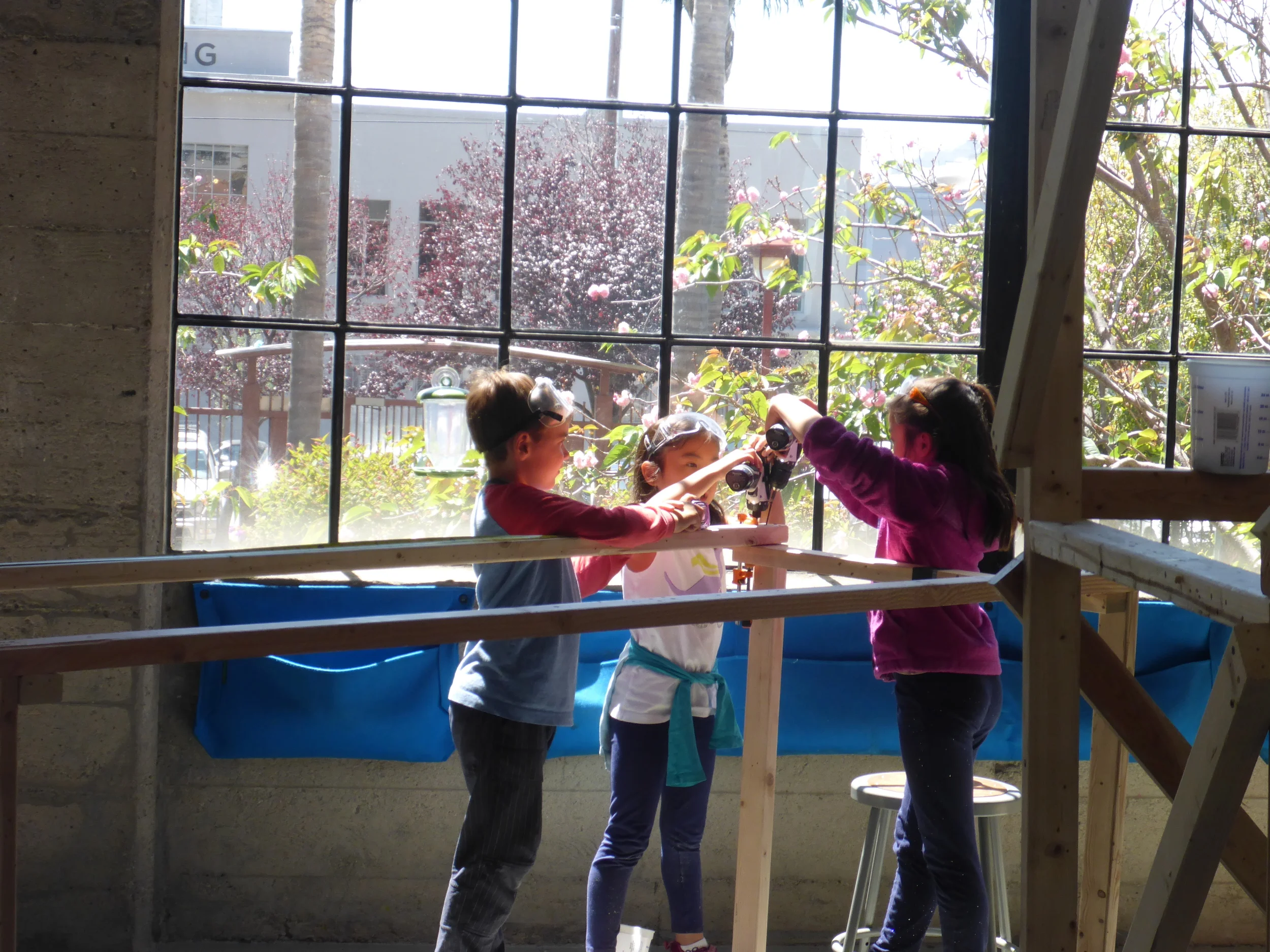 In the afternoon sunlight, the bridge team works together to assemble the eight-foot towers that will eventually support our suspension bridge. 
