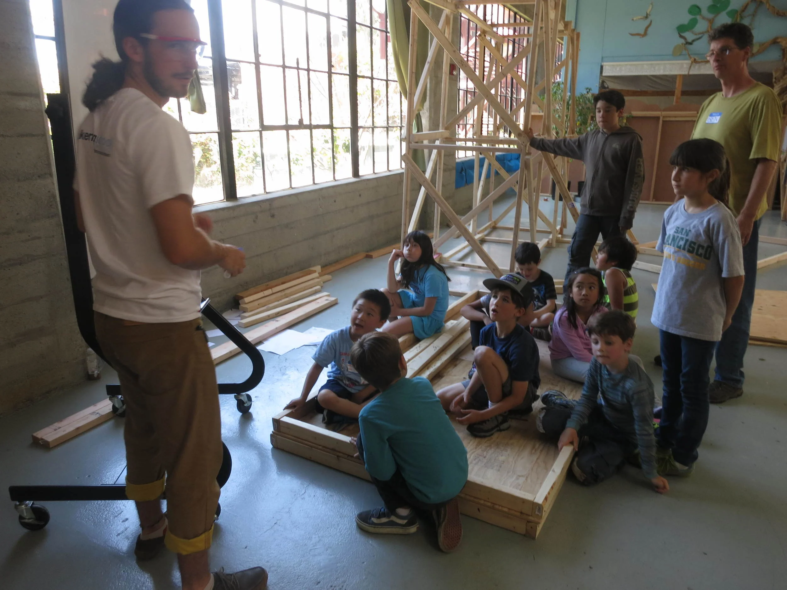 The bridge building team pauses for a quick regroup and team meeting. 