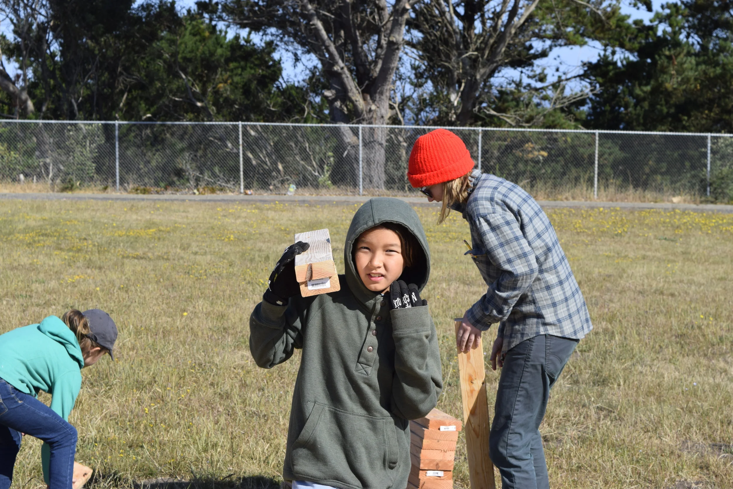 Lee grabs 2x4's — the track team is hoarding. 