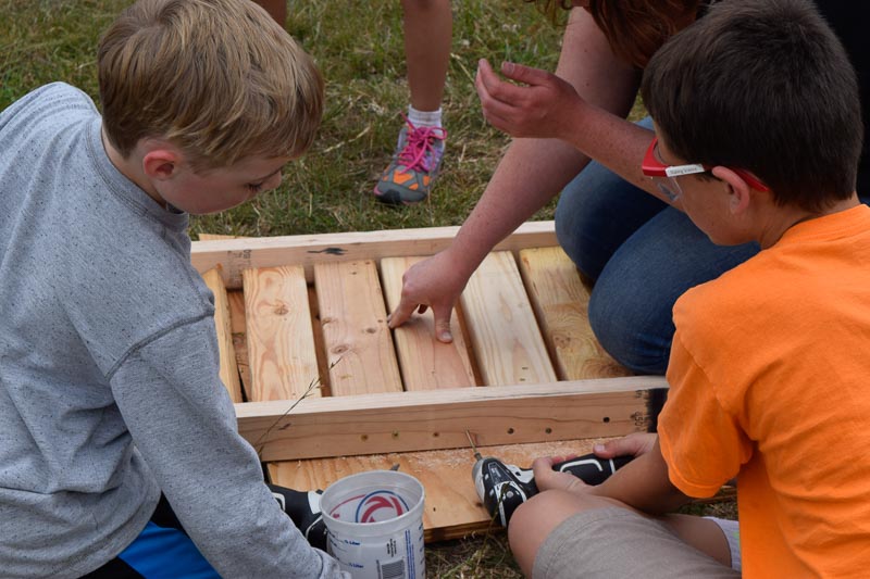 Harrison and Jack work together to complete the seat