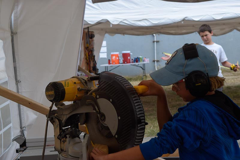 Kelly cuts an angle on the chopsaw.