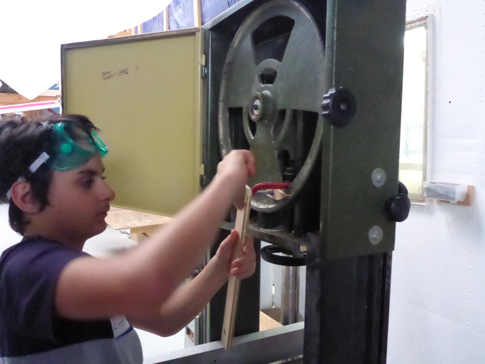 Experimenting with ways to turn the band saw wheels. 