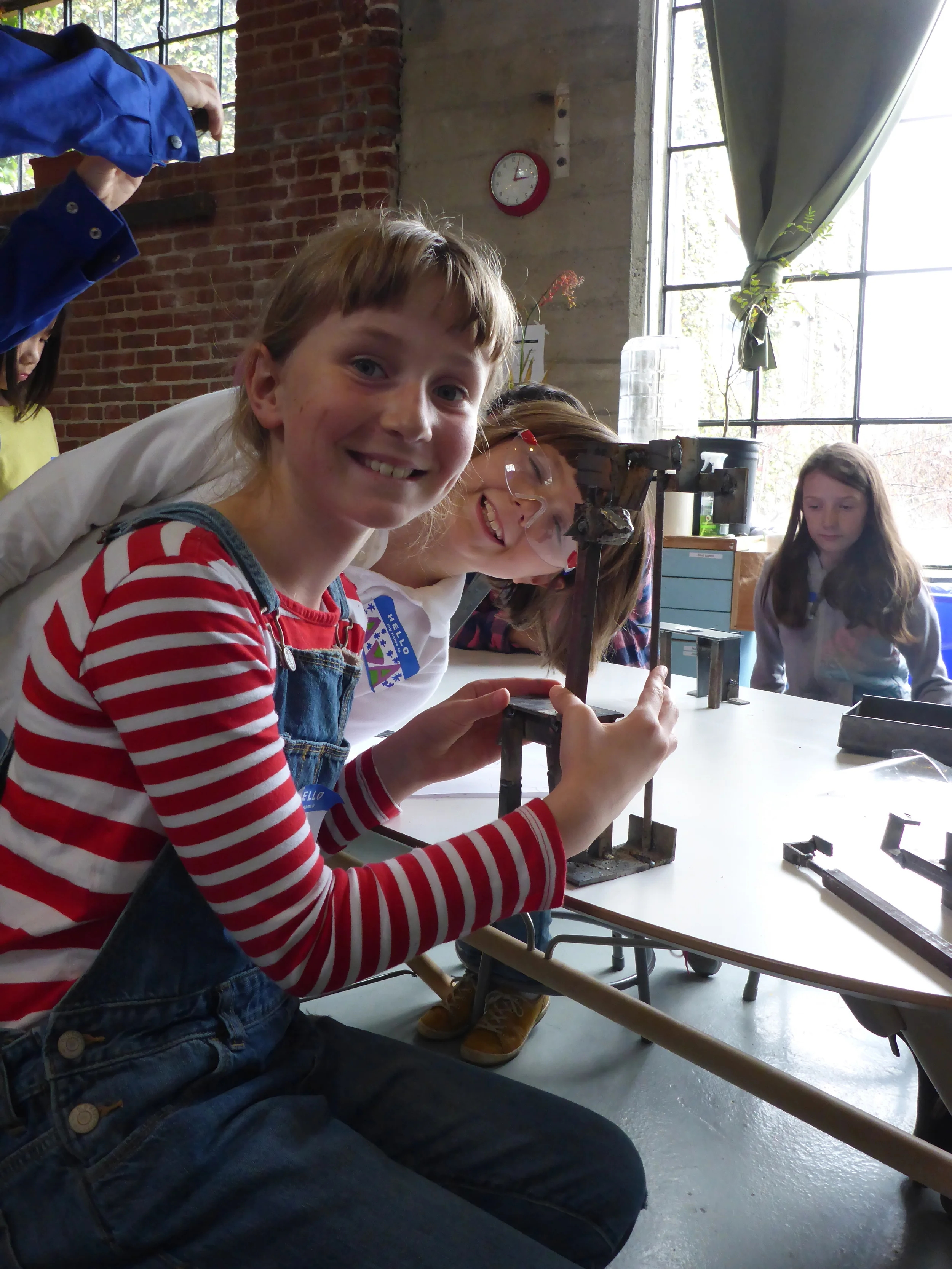 Lulu (and Ava!) with her giraffe and tree sculpture. Lulu is a welding regular; she started this sculpture at her last workshop a few weeks ago, and brought the head back today to finish making the body.