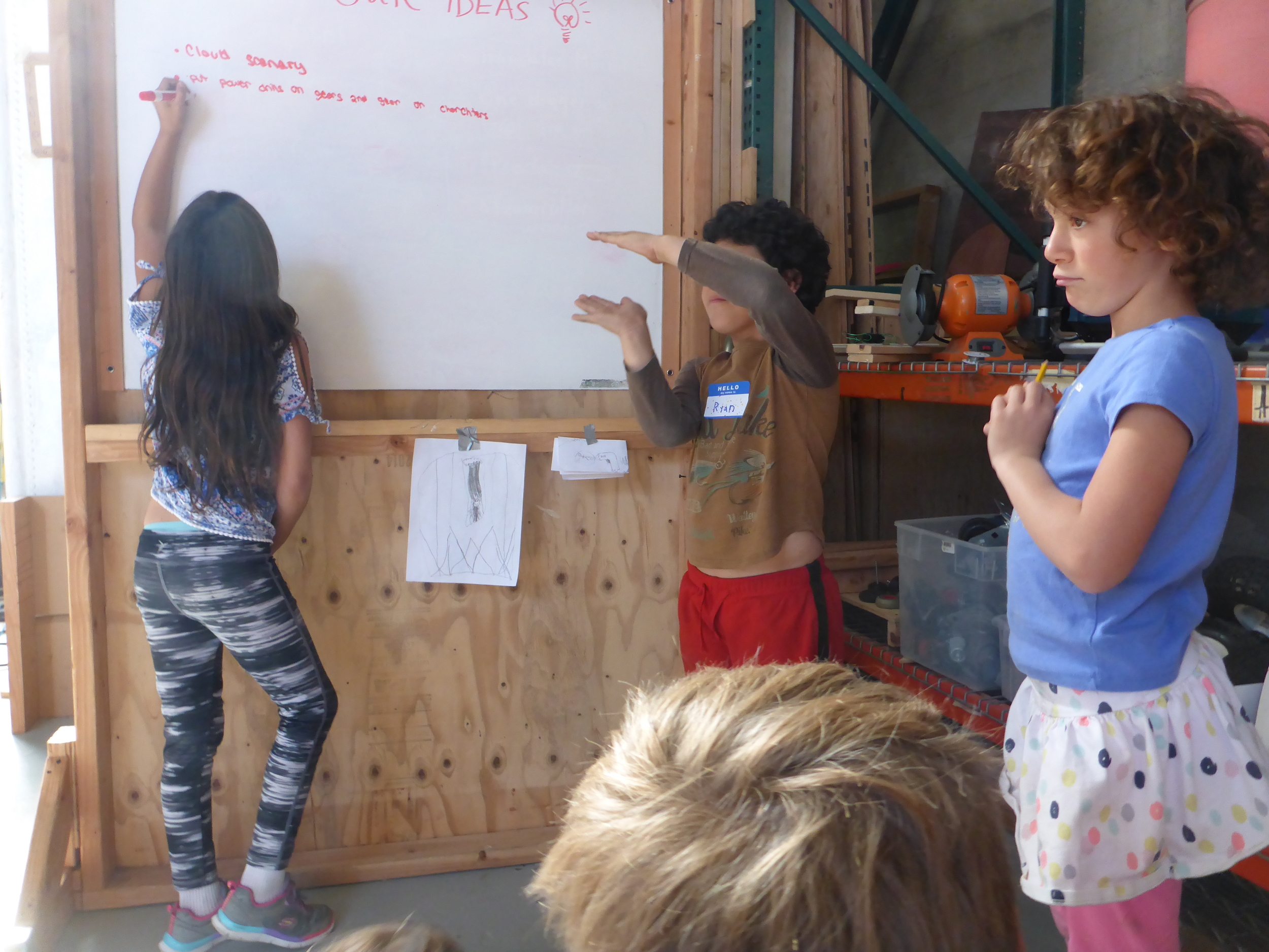Dimensions can be hard: Ryan uses his hands to show the group how big he thinks a part of his puppet should be. 