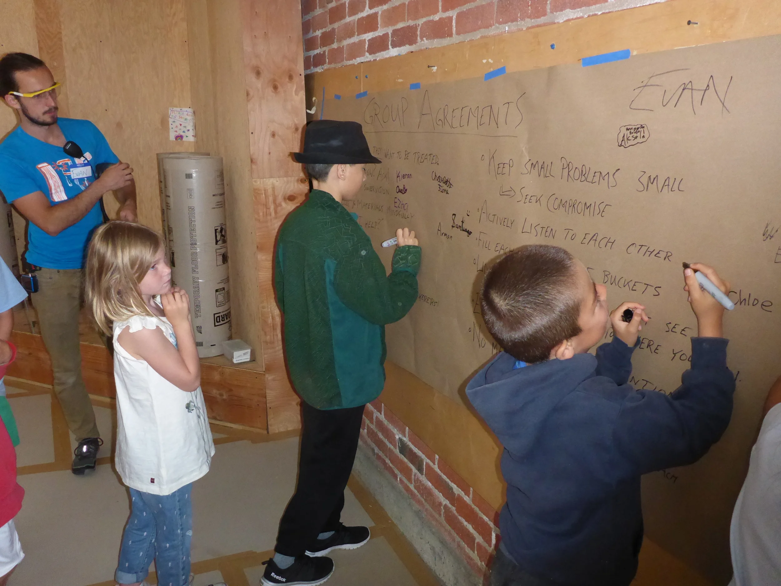 Tinkerers signing their names to the group agreement
