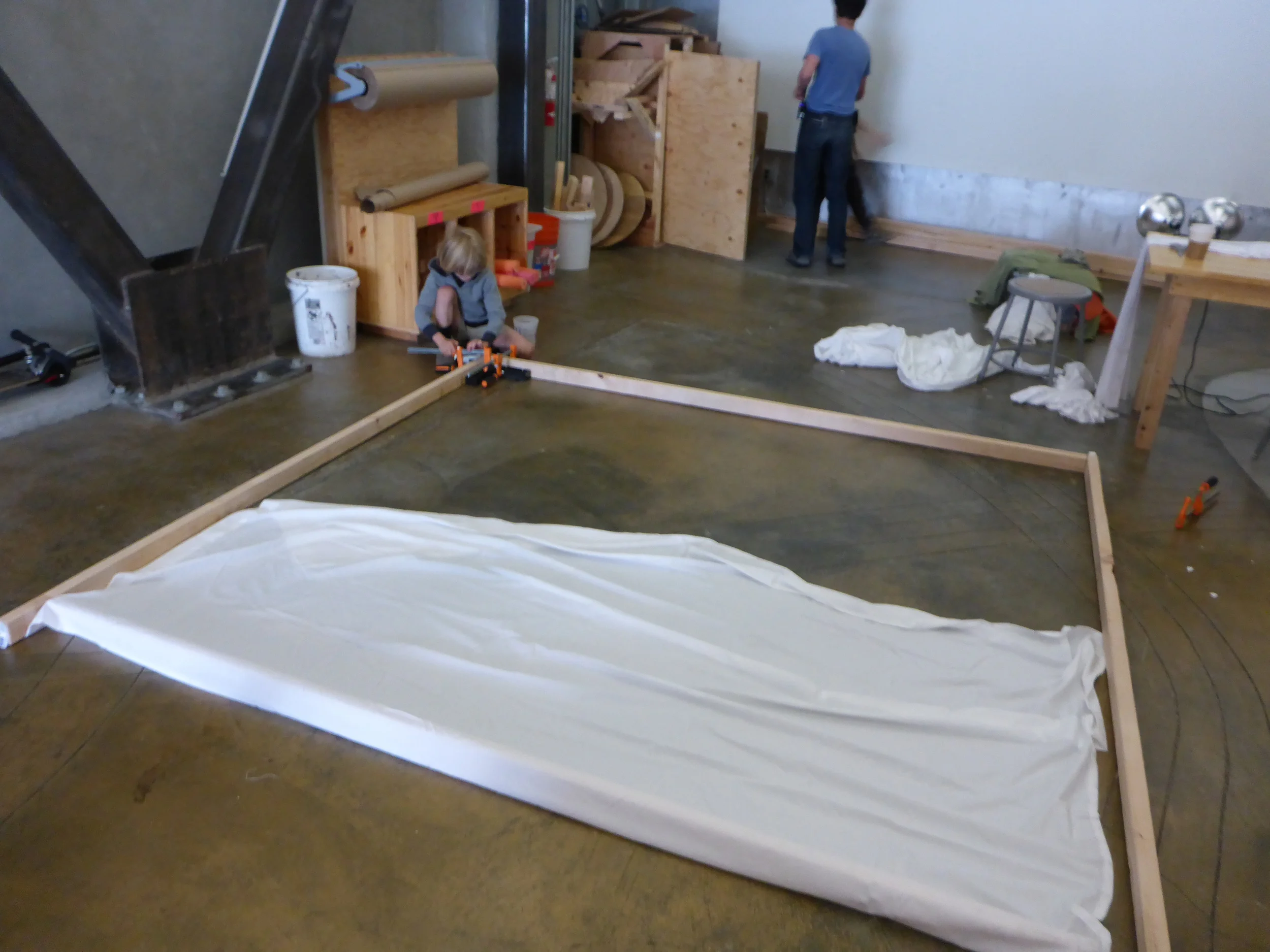 Nolan works on connecting a corner for the huge frame that will be covered in cloth to capture the shadows of the animals being made.  