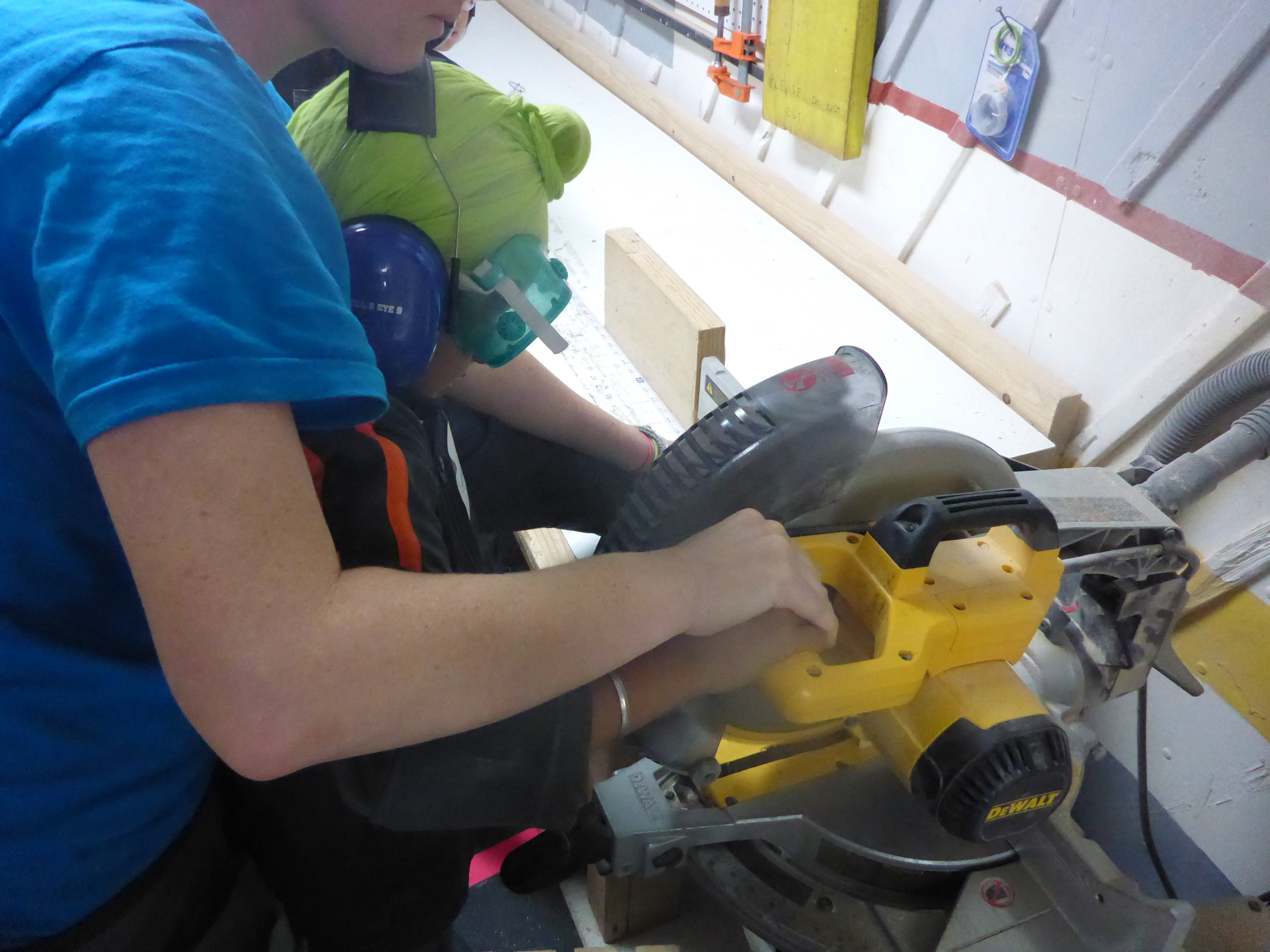 Lindsay helps Gurneet get to know what will become his favorite tool of the day - the Chopsaw!