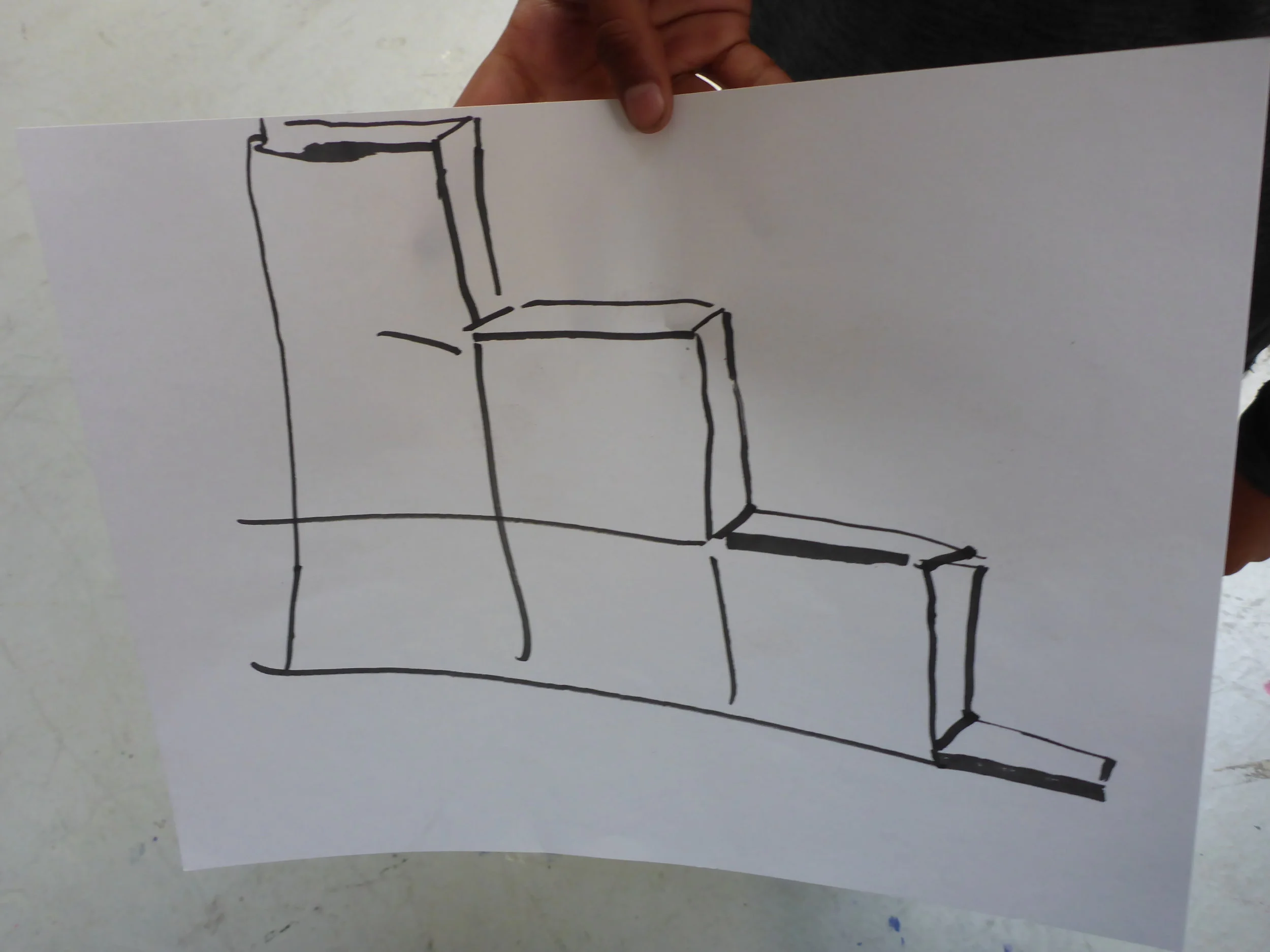 Niki does the final design drawing of our goal for the day - Giant steps!