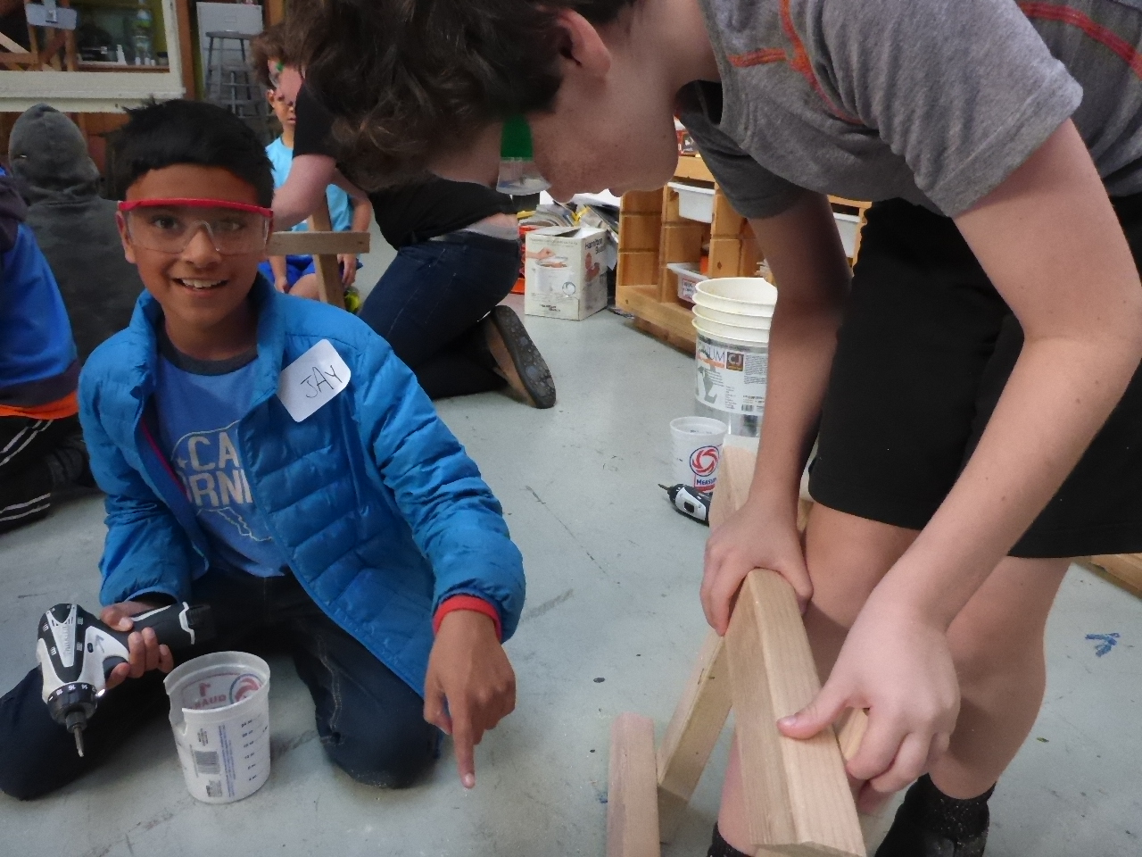 Jay practices drilling with teammates to make some rectangles. 