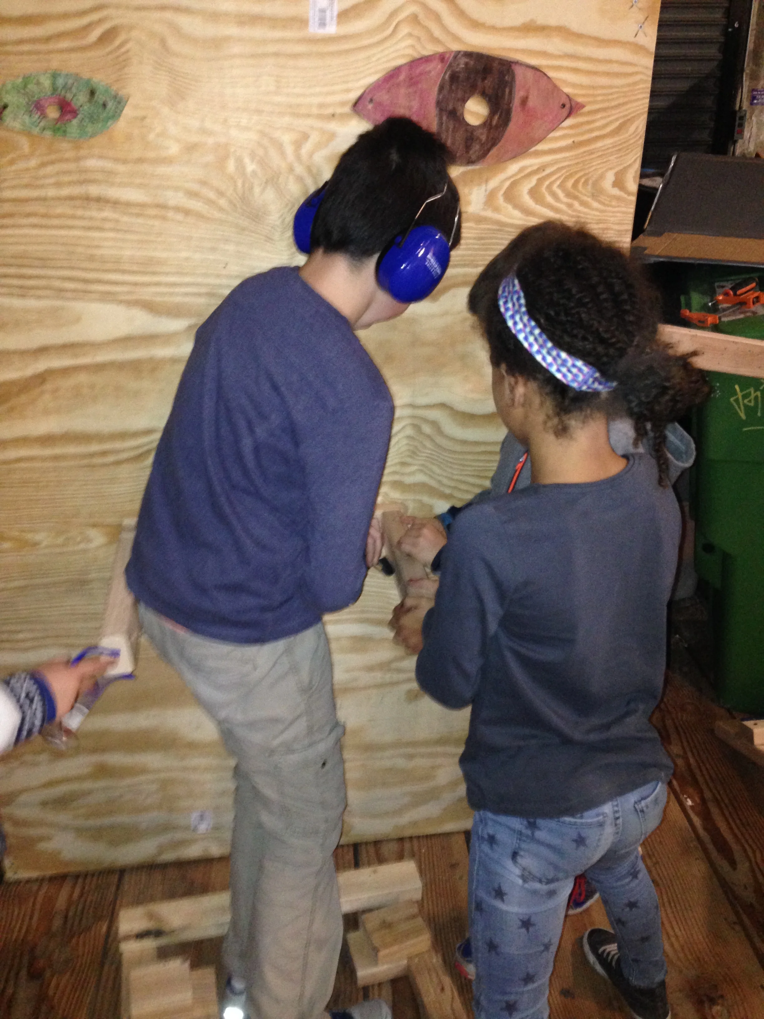 Together they worked to screw in an extra support shelf to hold it. 