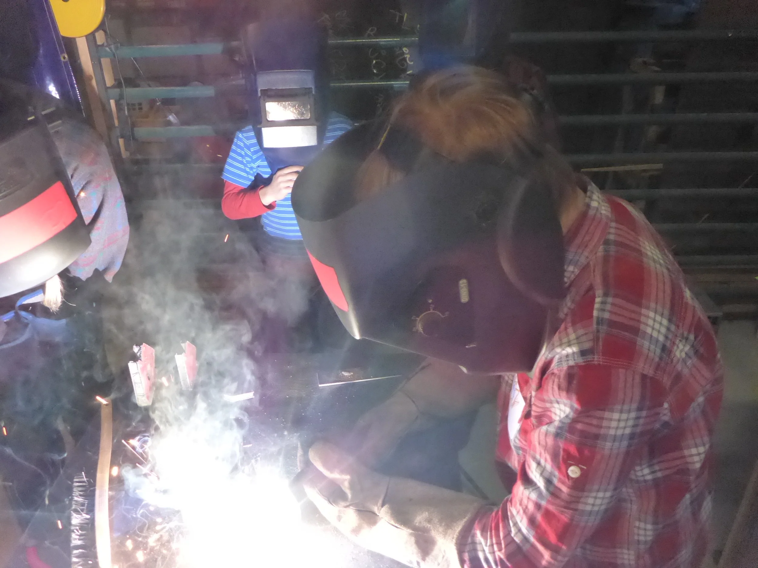 Sadie lays down her first bead! She noticed that at first the tip of the welding gun was too far away. This caused the electrode to get to long and break off!