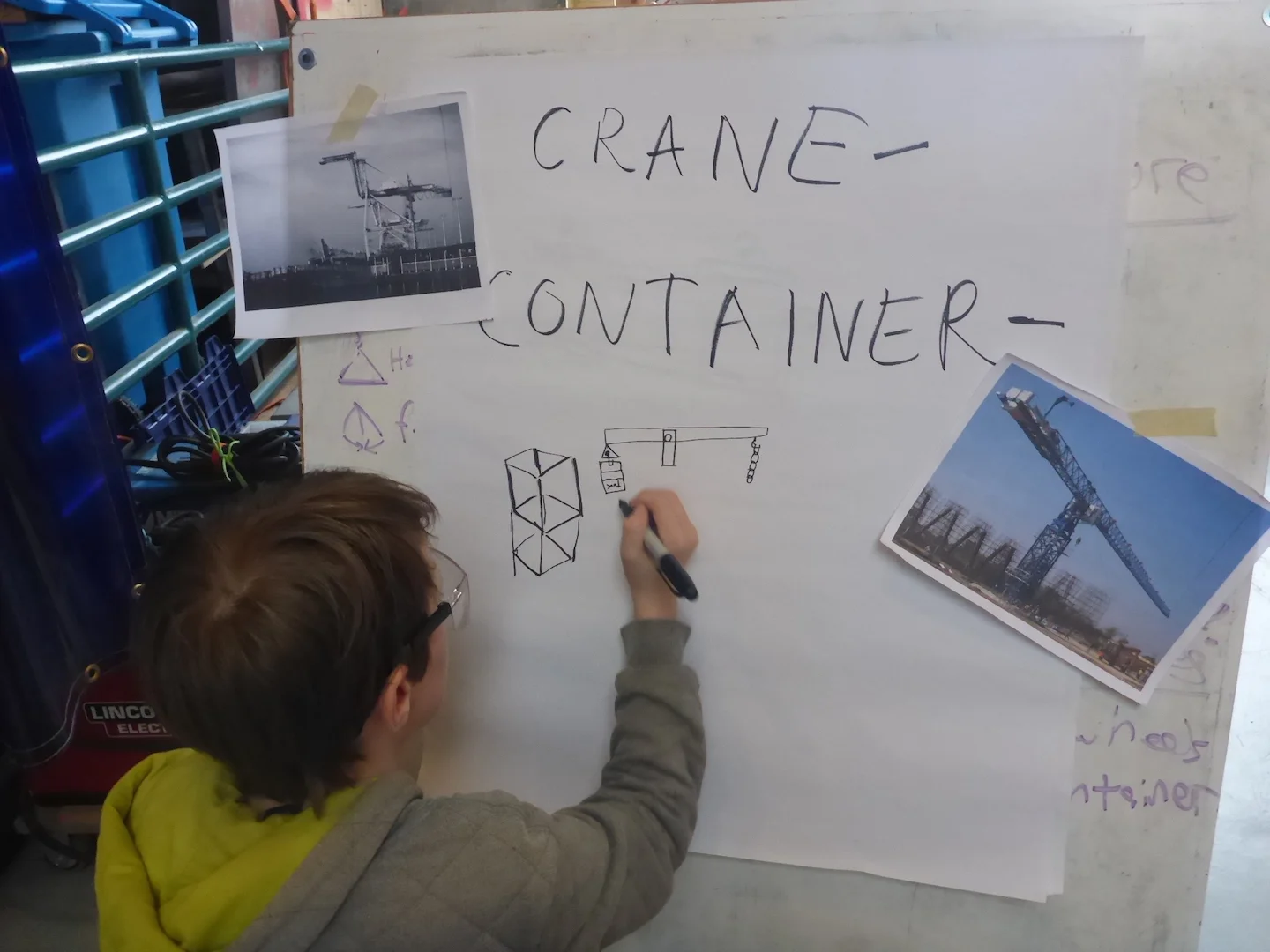 Leo draws his ideas for a mechanism to keep the crane balanced