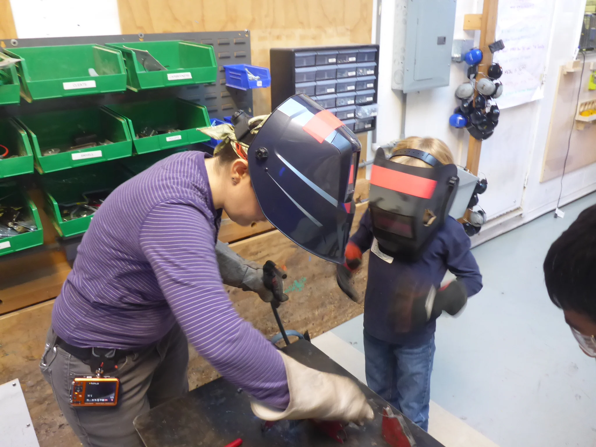 Amanda and Alex get ready to weld pieces for his tank.