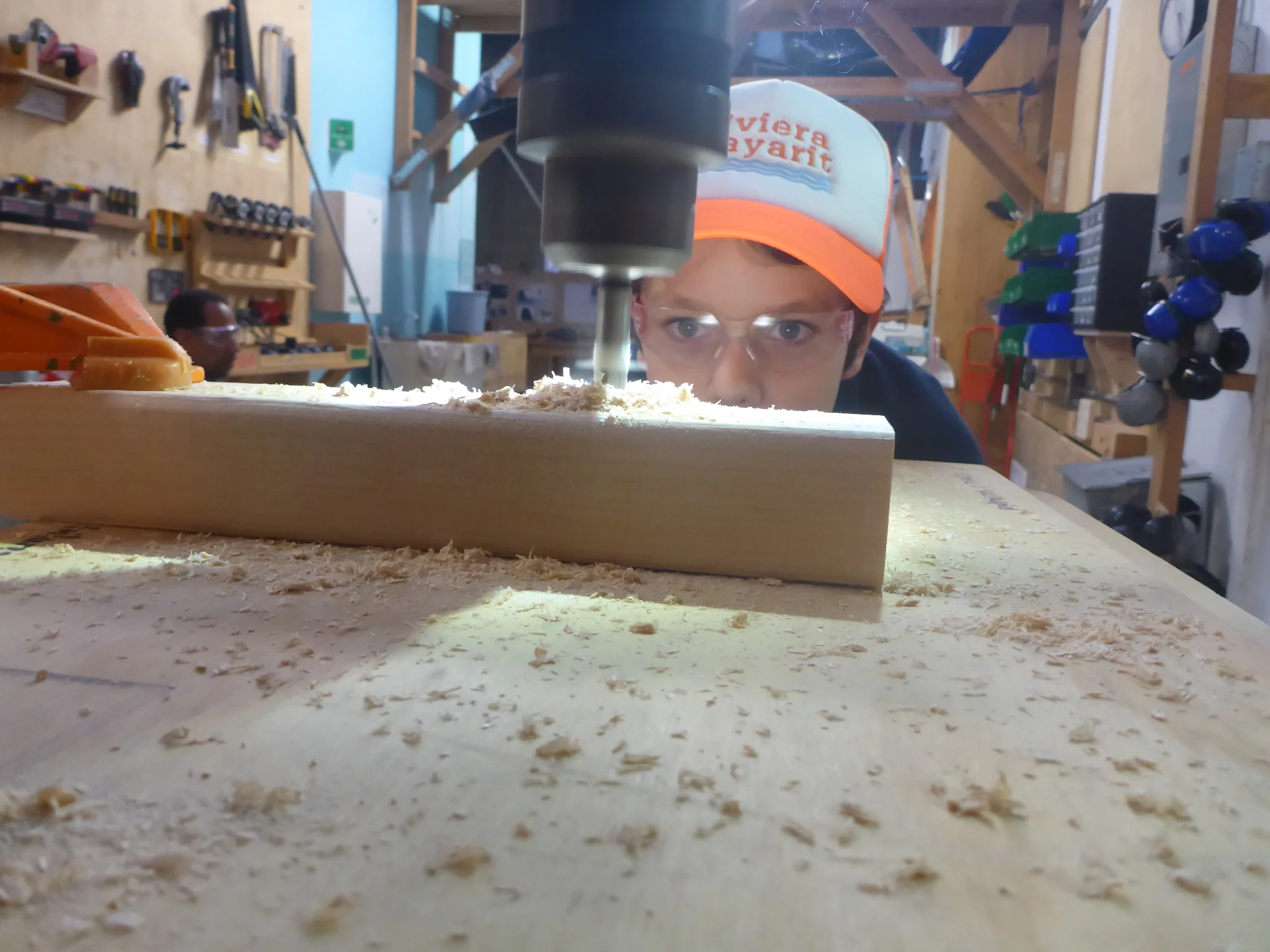 Here you can see a piece of tape we put on the drill bit at the depth of the wood, so we wouldn't drill into the table too far!