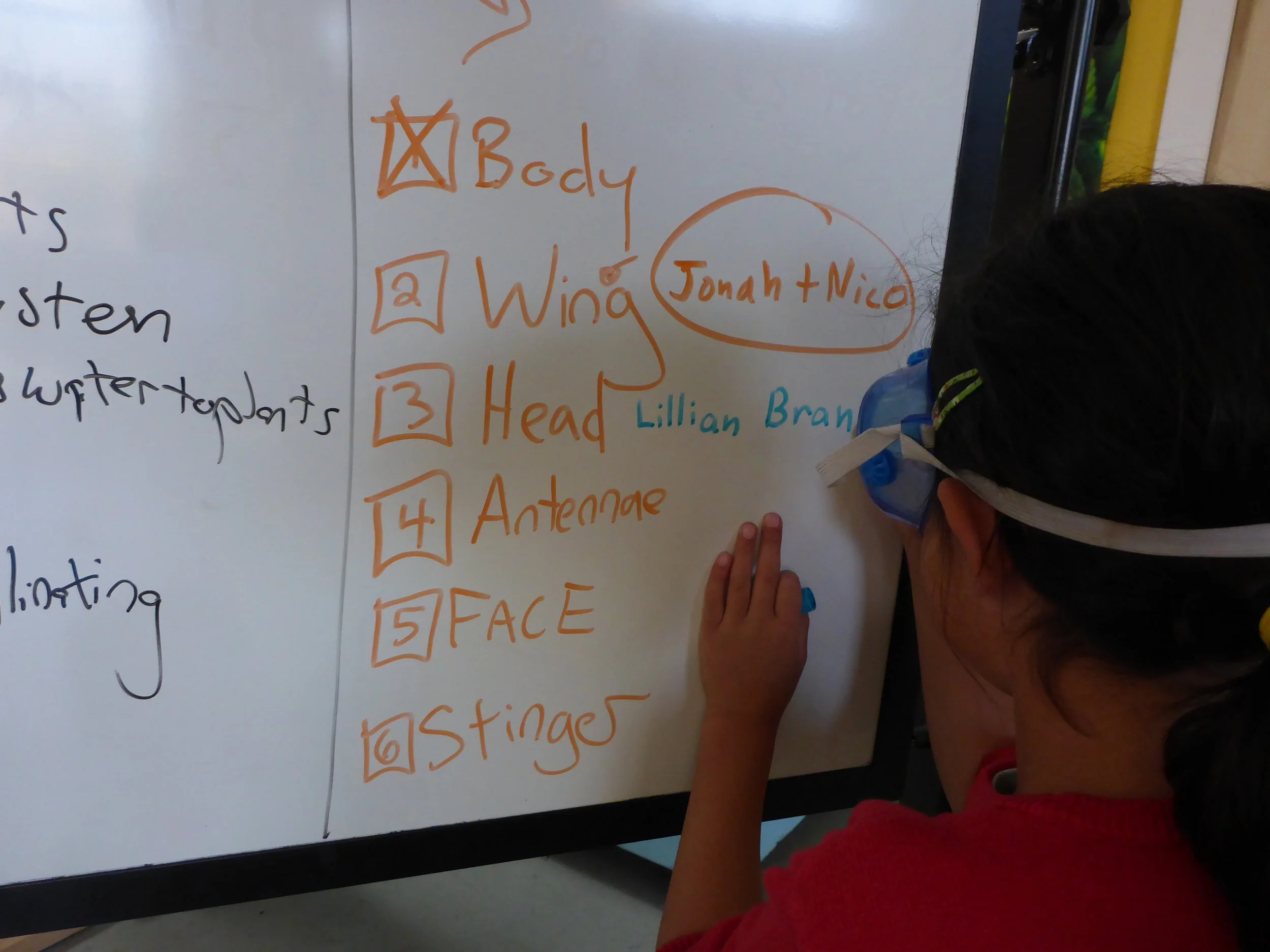 Lillian writes her and Brandon's name next to the task they are taking on.