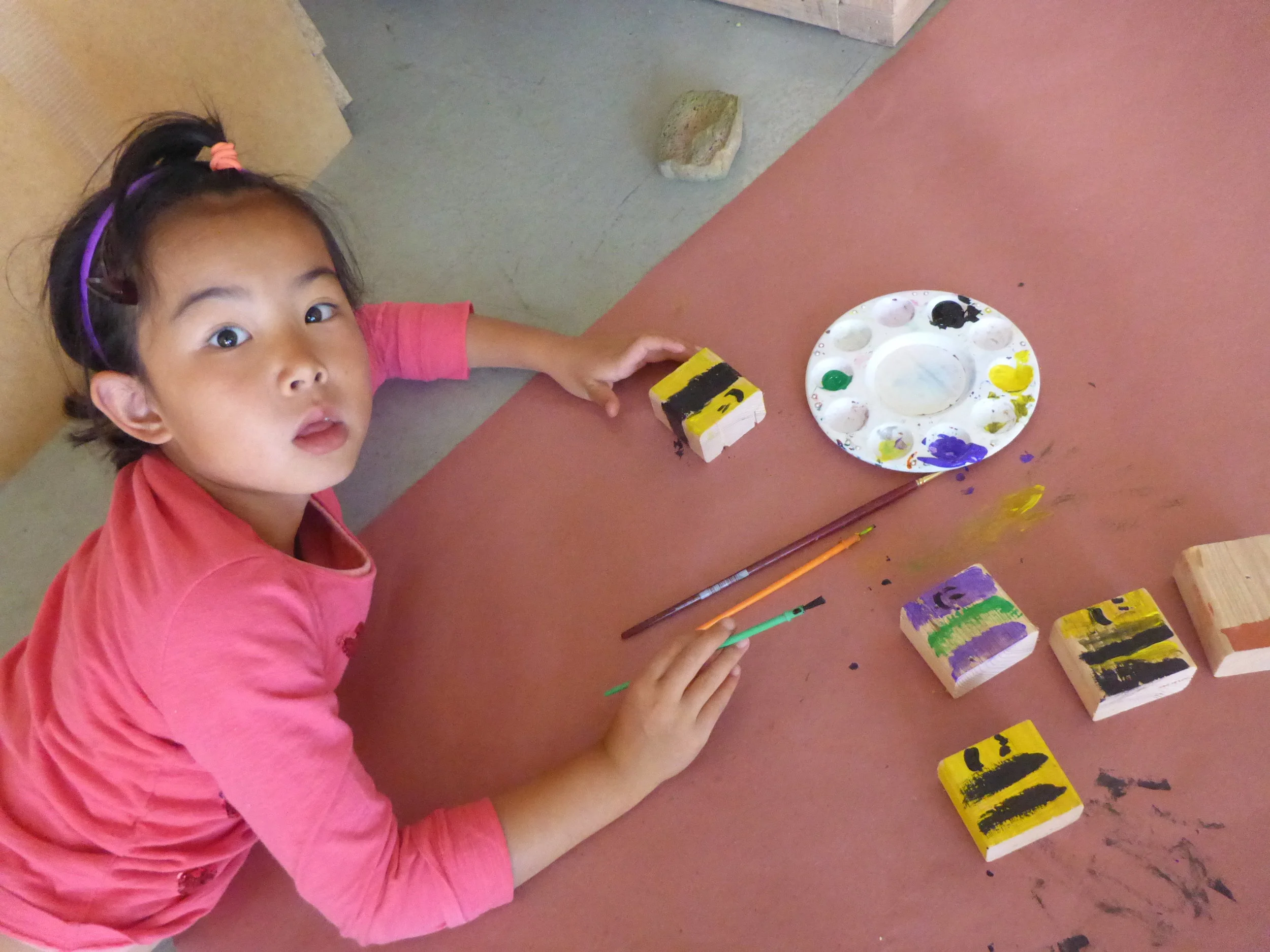Lilly paints some tiny bees.