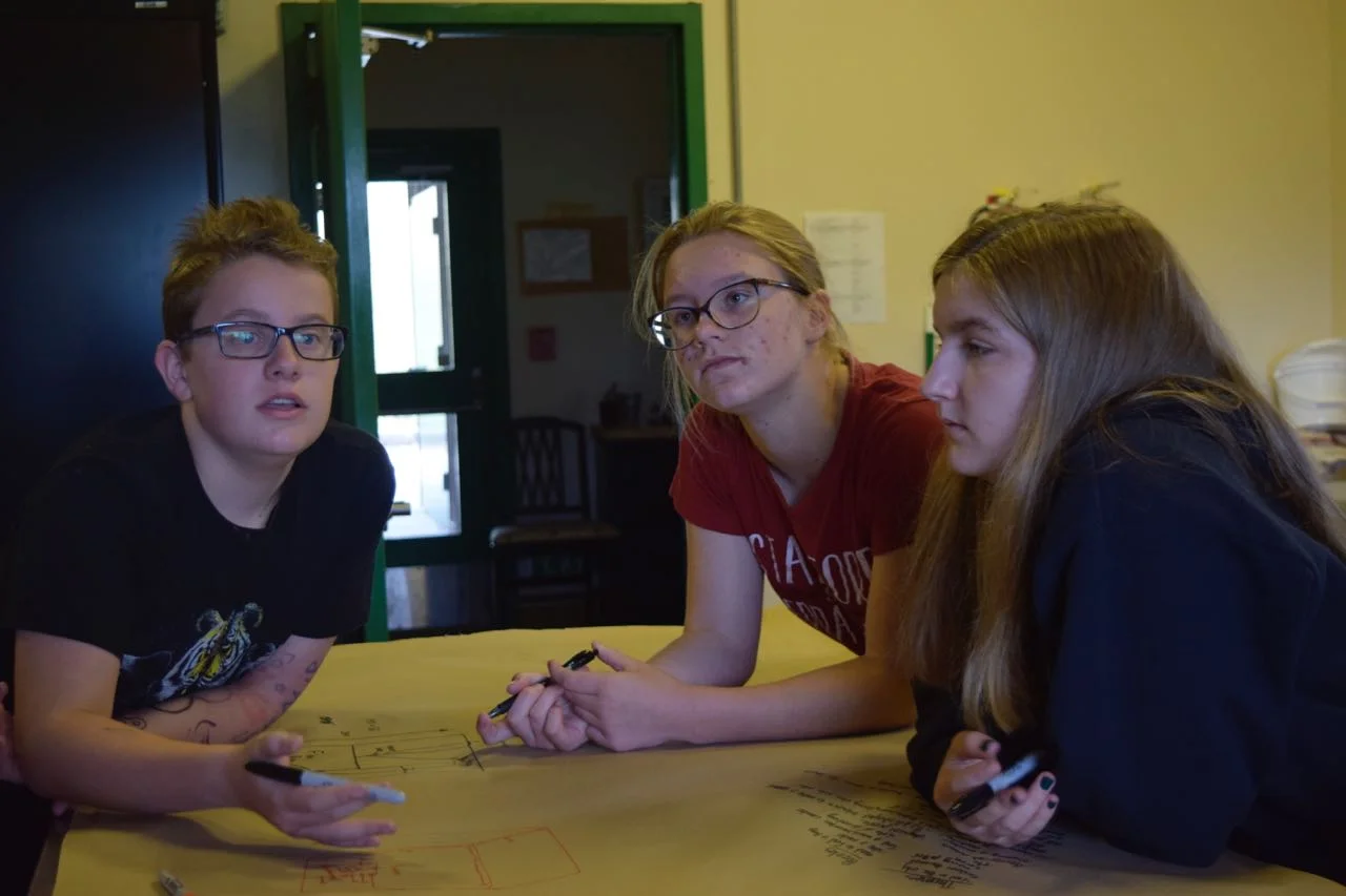 Nooi takes their design meeting to the kitchen for extra protection against accidental eavesdroppers. Ft. Reilly, Merritt, and Sarah P.