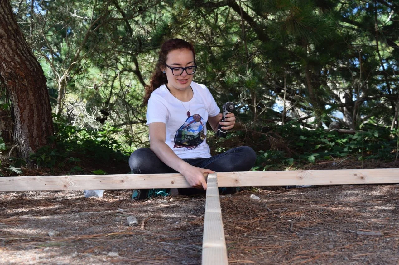 Sophia gets ready to screw another frame together.