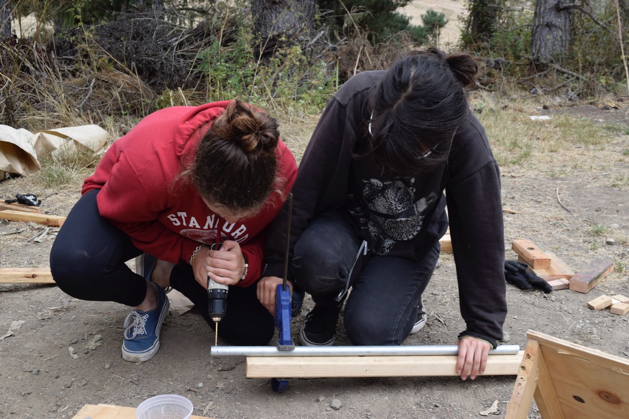 With Sayuri's help, Emma drills holes in a section of pipe, from which Nooi will suspend their melon.&nbsp;