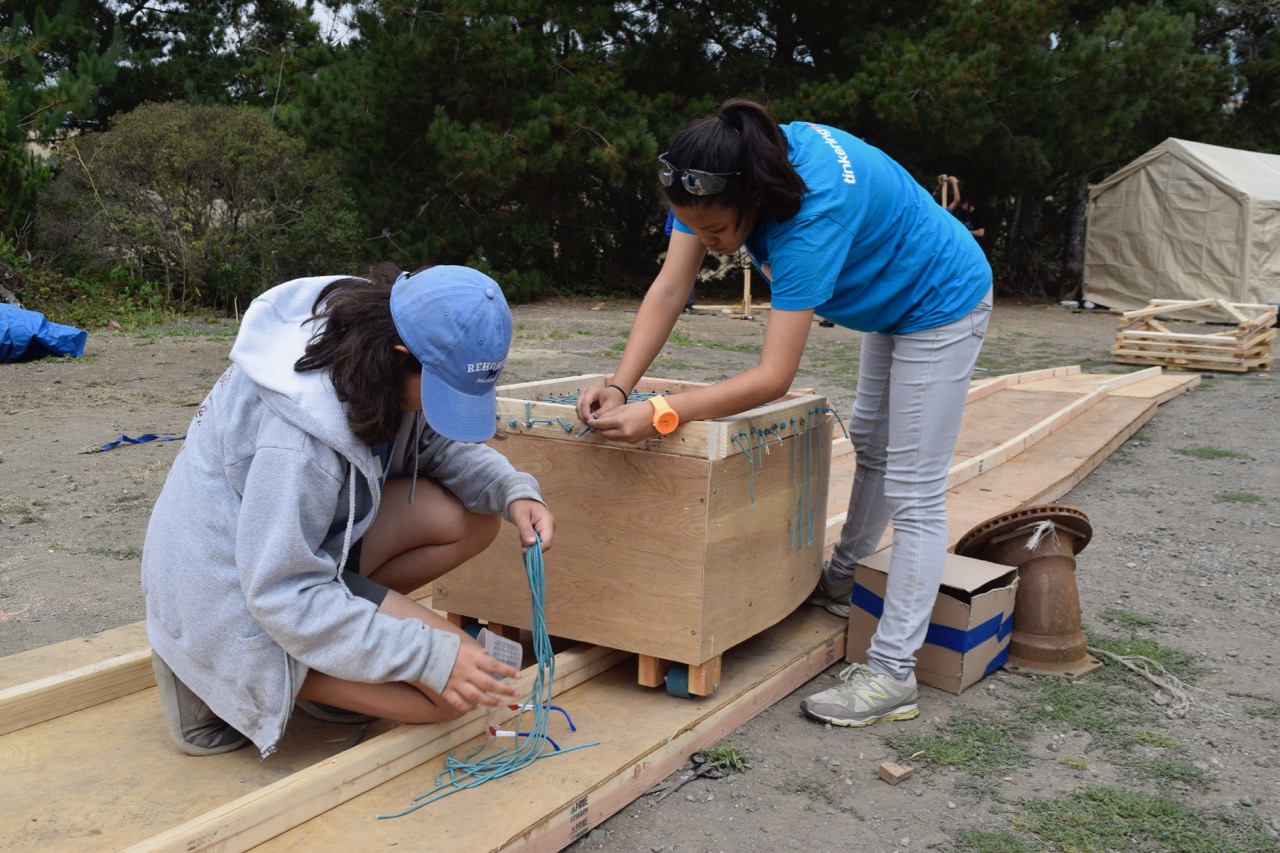 Katelin and Sage weave a basket for Panda's melon in order to comply with the six inch rule.&nbsp;